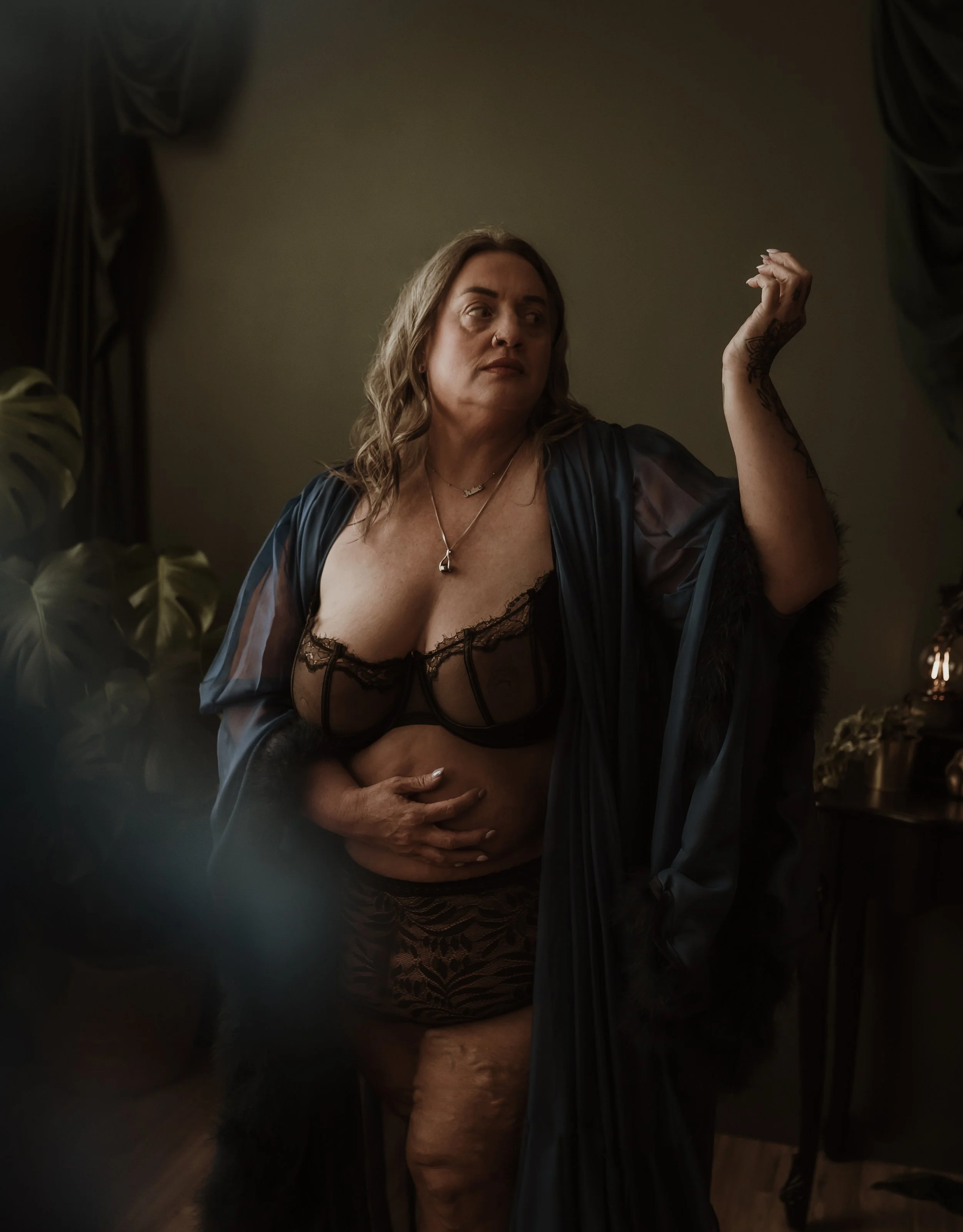 A client during her boudoir photography session at Marieke Captures, Glasgow — captured in a moment of natural confidence during her guided studio experience.
