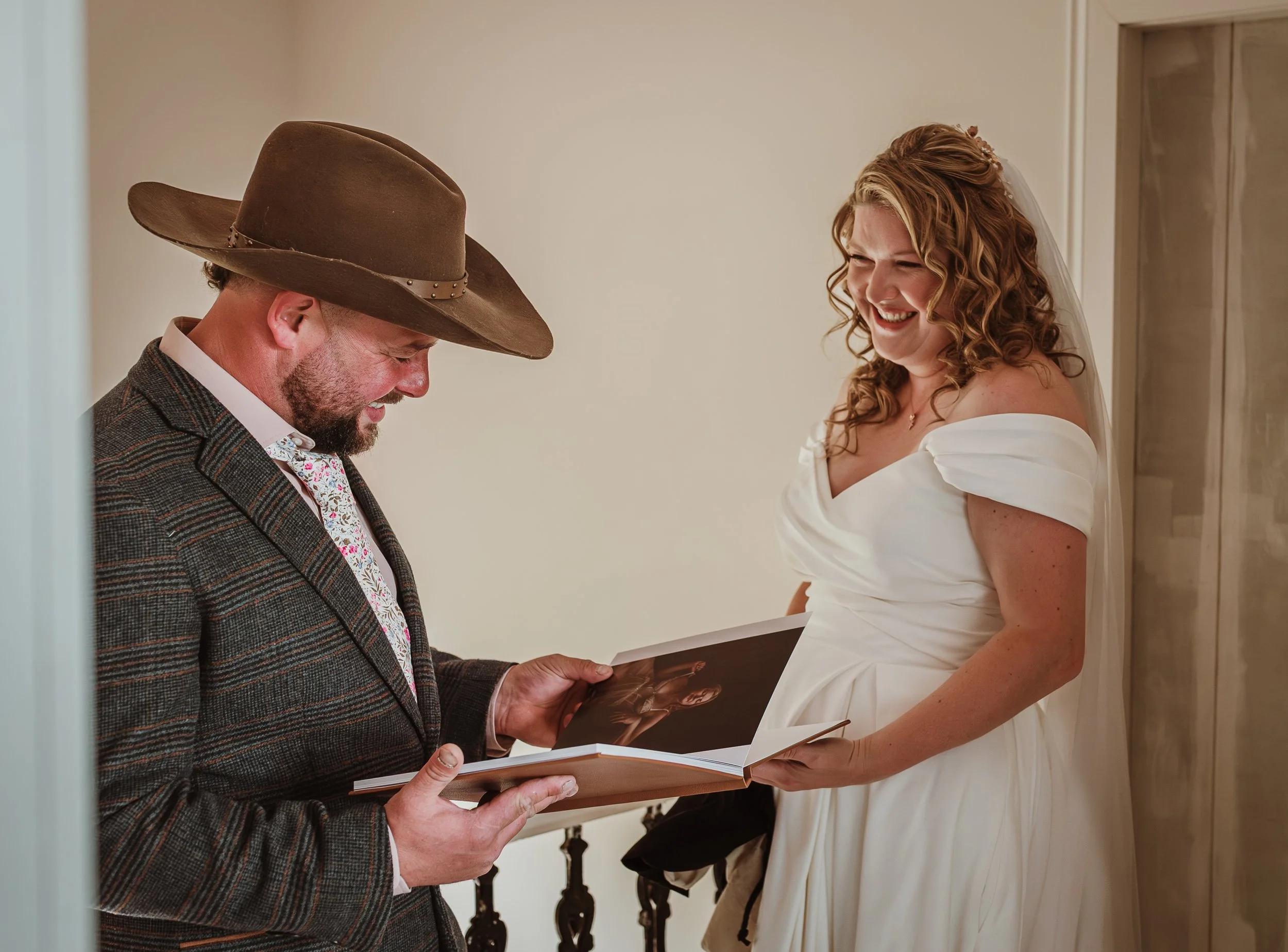 Bride presenting her wedding boudoir photography album as a gift to her husband at Marieke Captures studio in Glasgow — an intimate and emotional wedding day moment