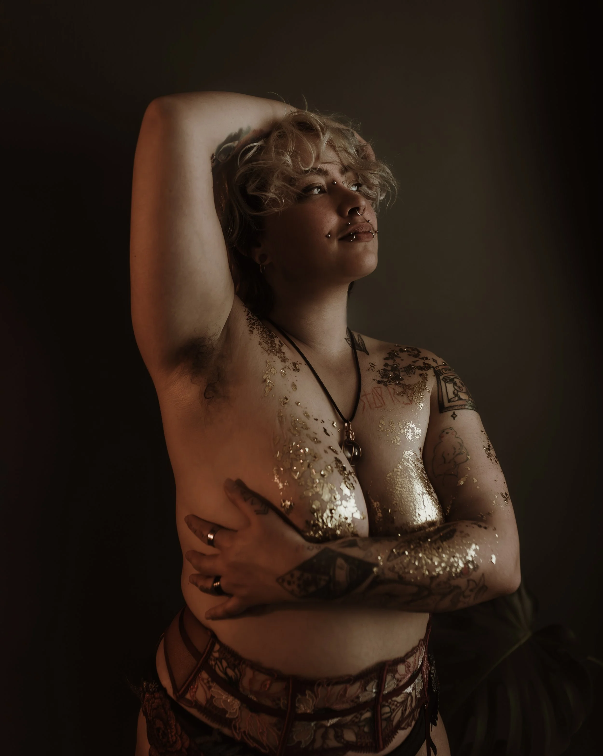 Artistic queer boudoir photograph of a trans man in Glasgow, Scotland, embracing softness and masculinity through inclusive boudoir photography at every stage of transition.
