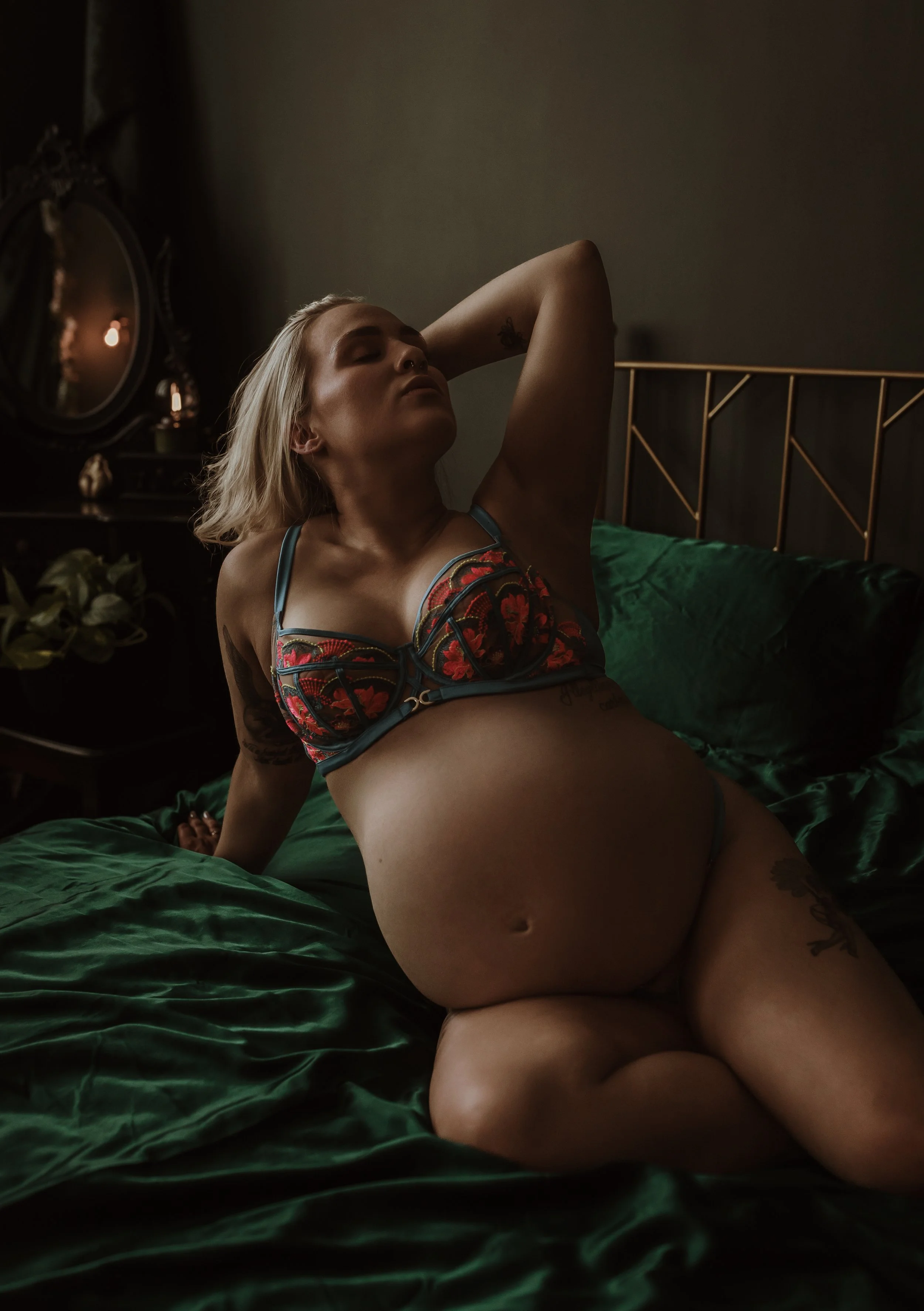 Empowering maternity boudoir photography at Marieke Captures studio Glasgow — pregnant woman on emerald silk bed in embroidered lingerie, confident and intimate studio portrait Scotland