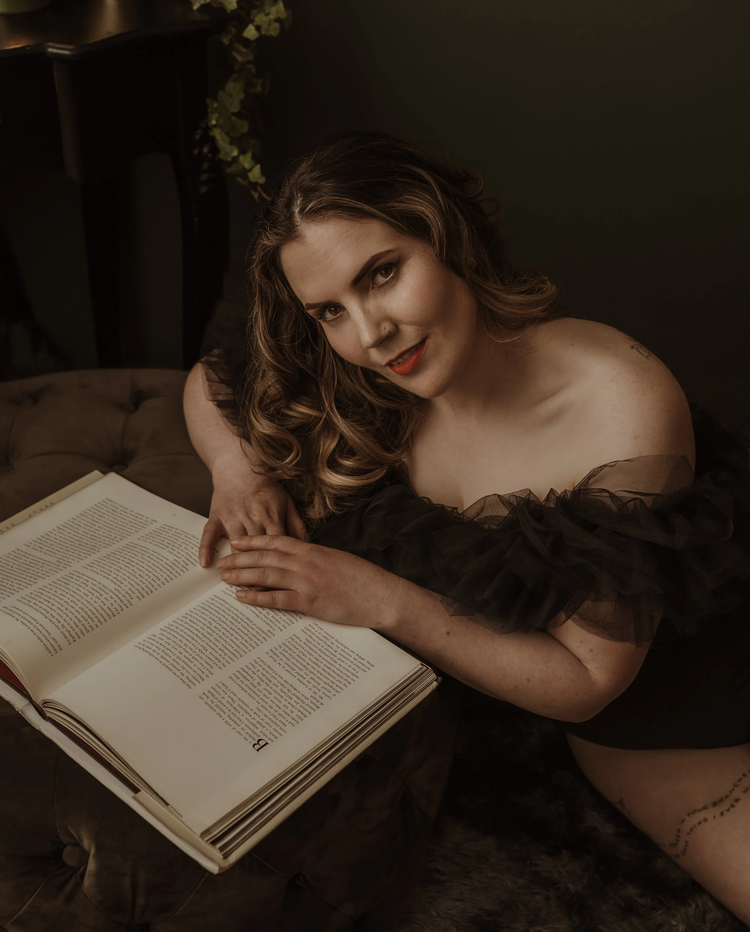 Close boudoir portrait of a client resting beside an open book, calm and at ease during a session at Marieke Captures, Glasgow