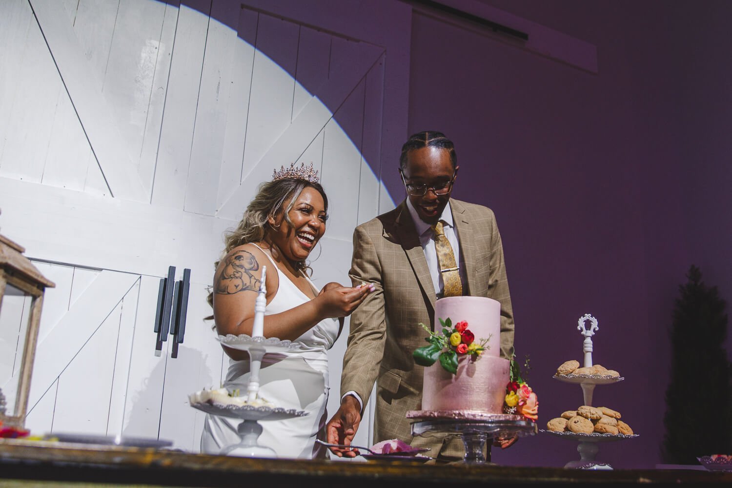 bride and groom cutting cake at creekside event center