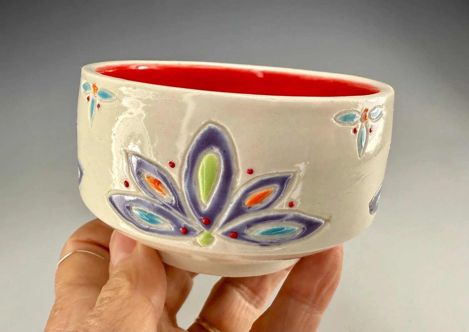 Hand holding Carved porcelain everything bowl