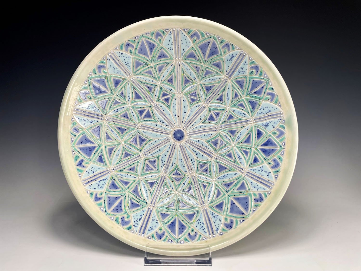 Intricately hand carved blue green purple porcelain bowl