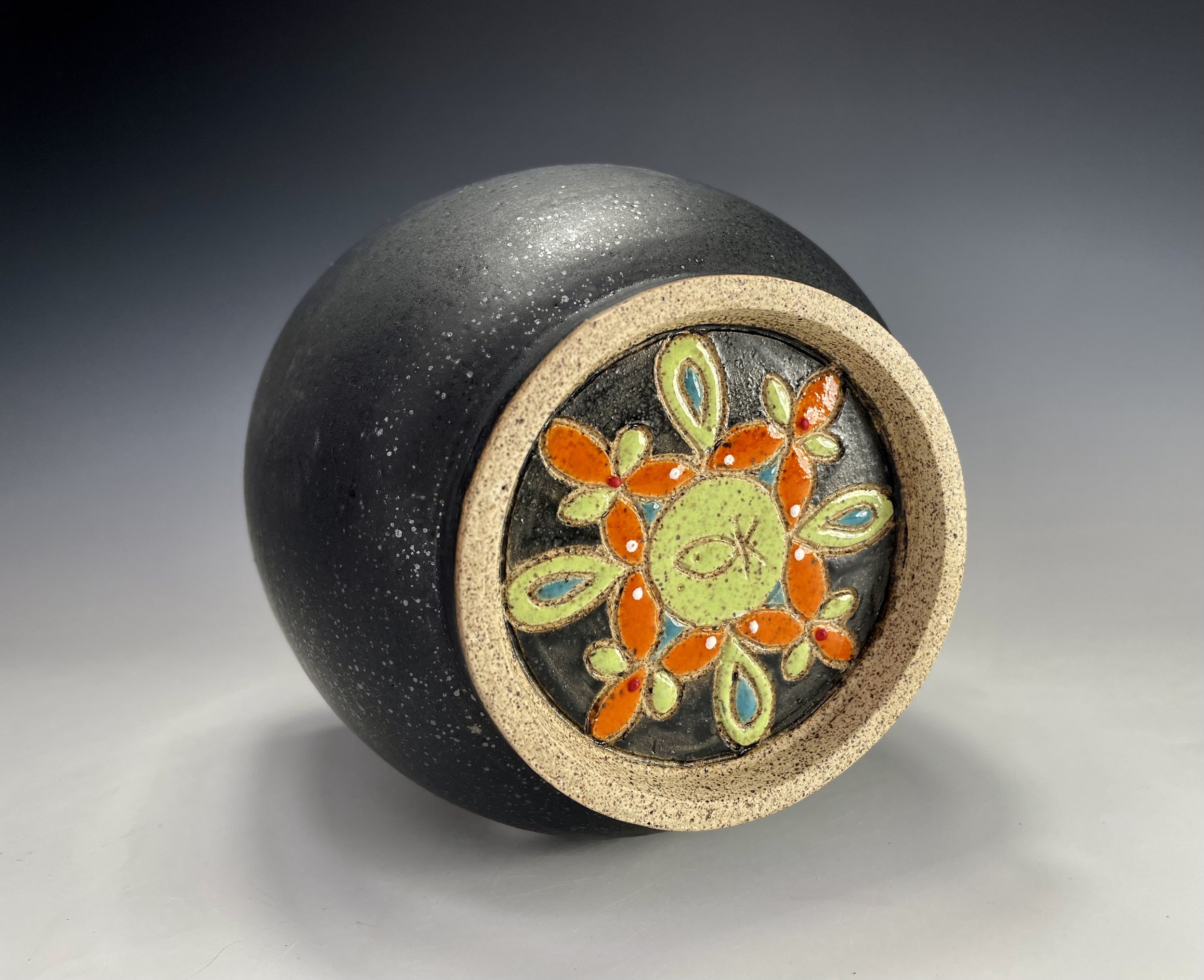 Carved design on bottom of Small black matte green circle vase