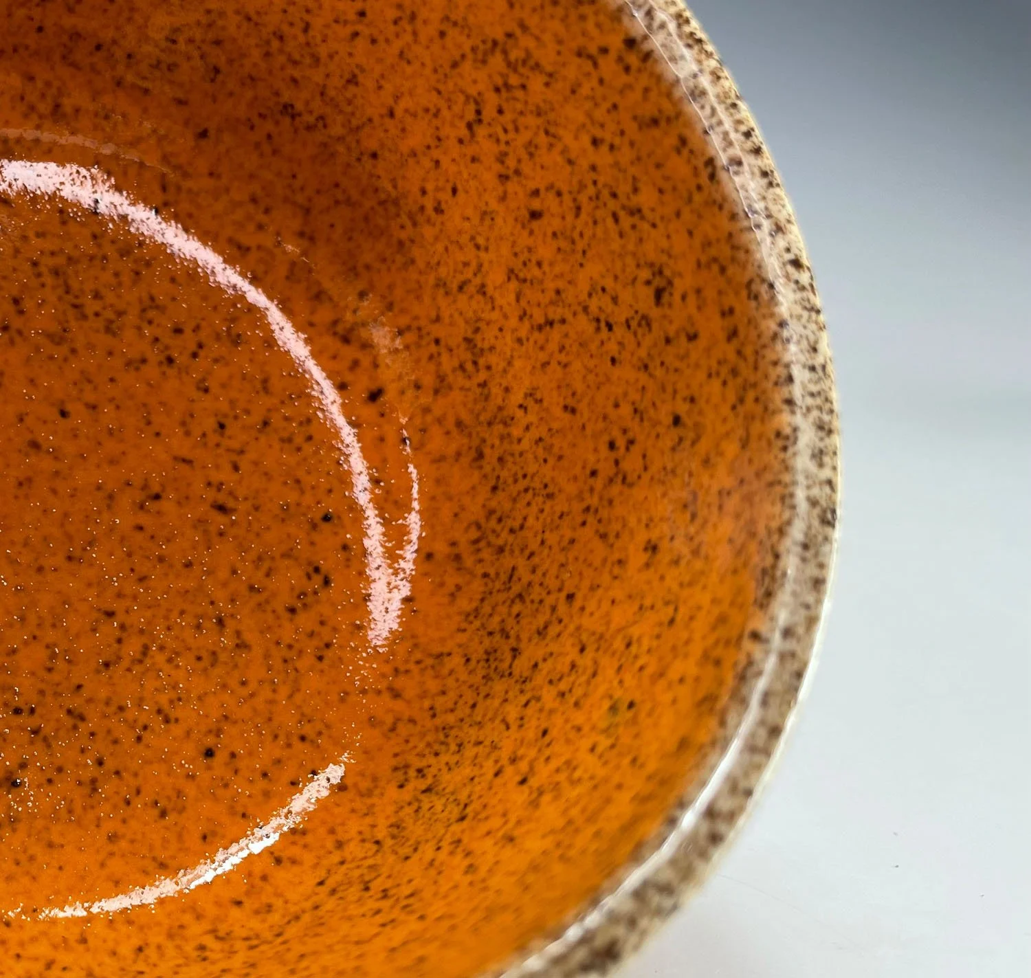Orange interior of Colorful tribal design hand carved stoneware latte mug