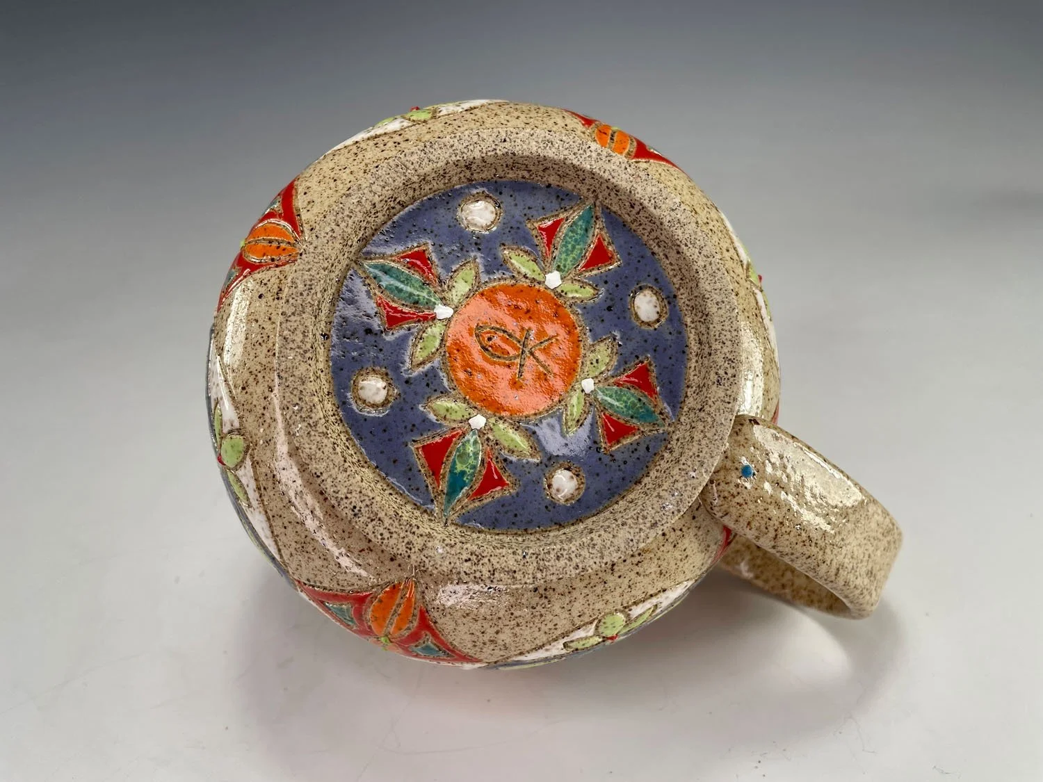 Bottom of Colorful tribal design hand carved stoneware latte mug