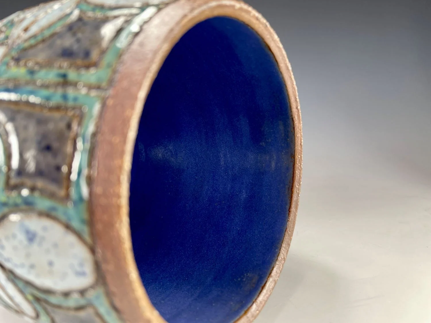 View of interior of Hand carved blue green stoneware flowerpot