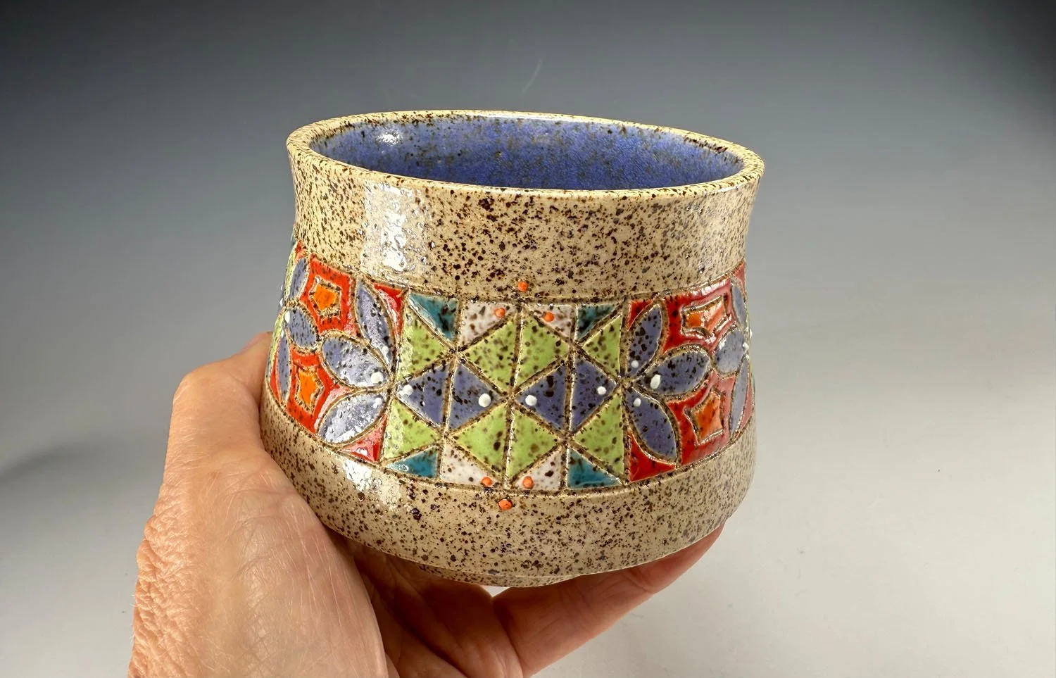 Hand holding Carved small stoneware bowl
