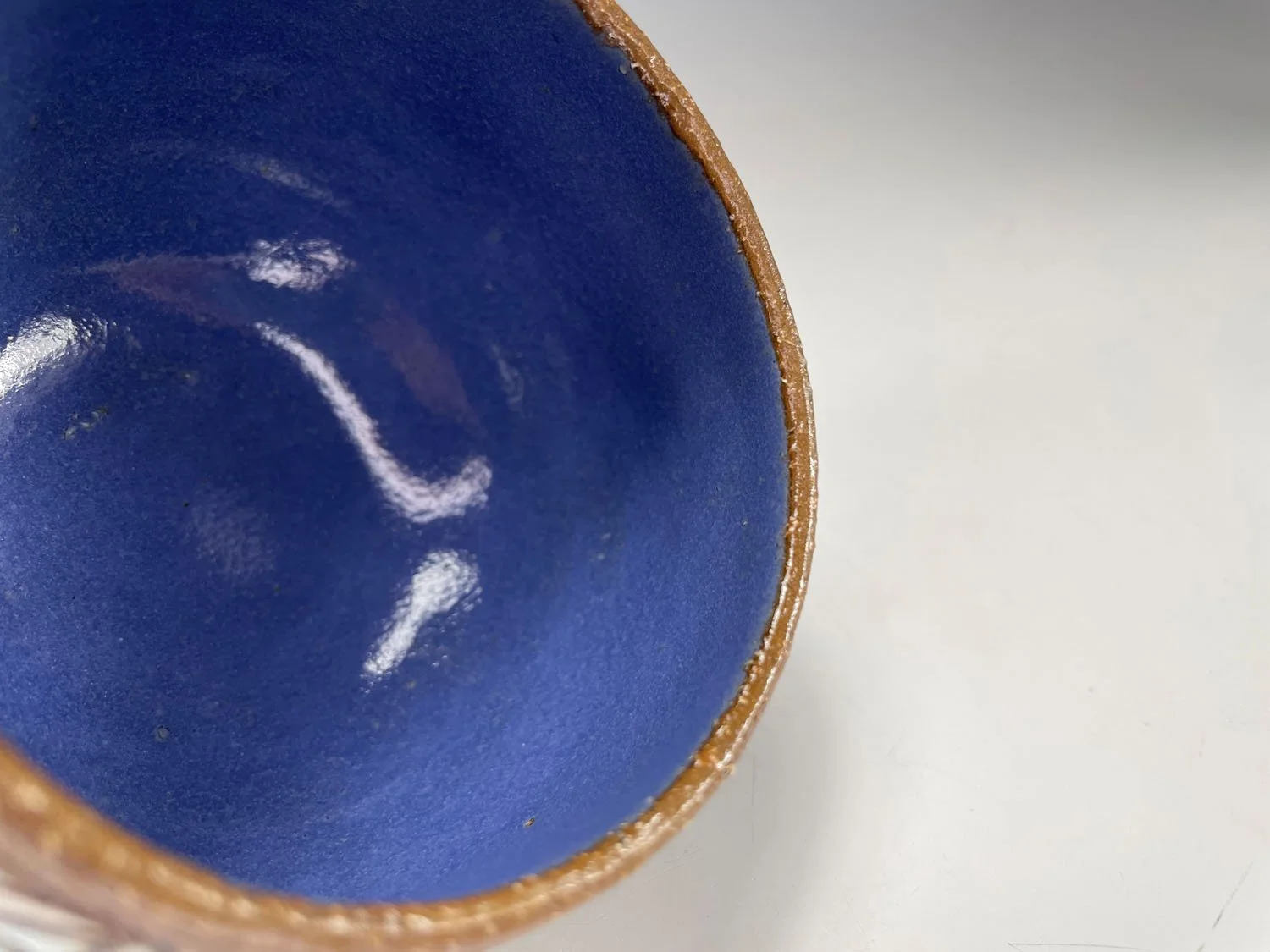 Inside blue liner of Carved stoneware cup bowl