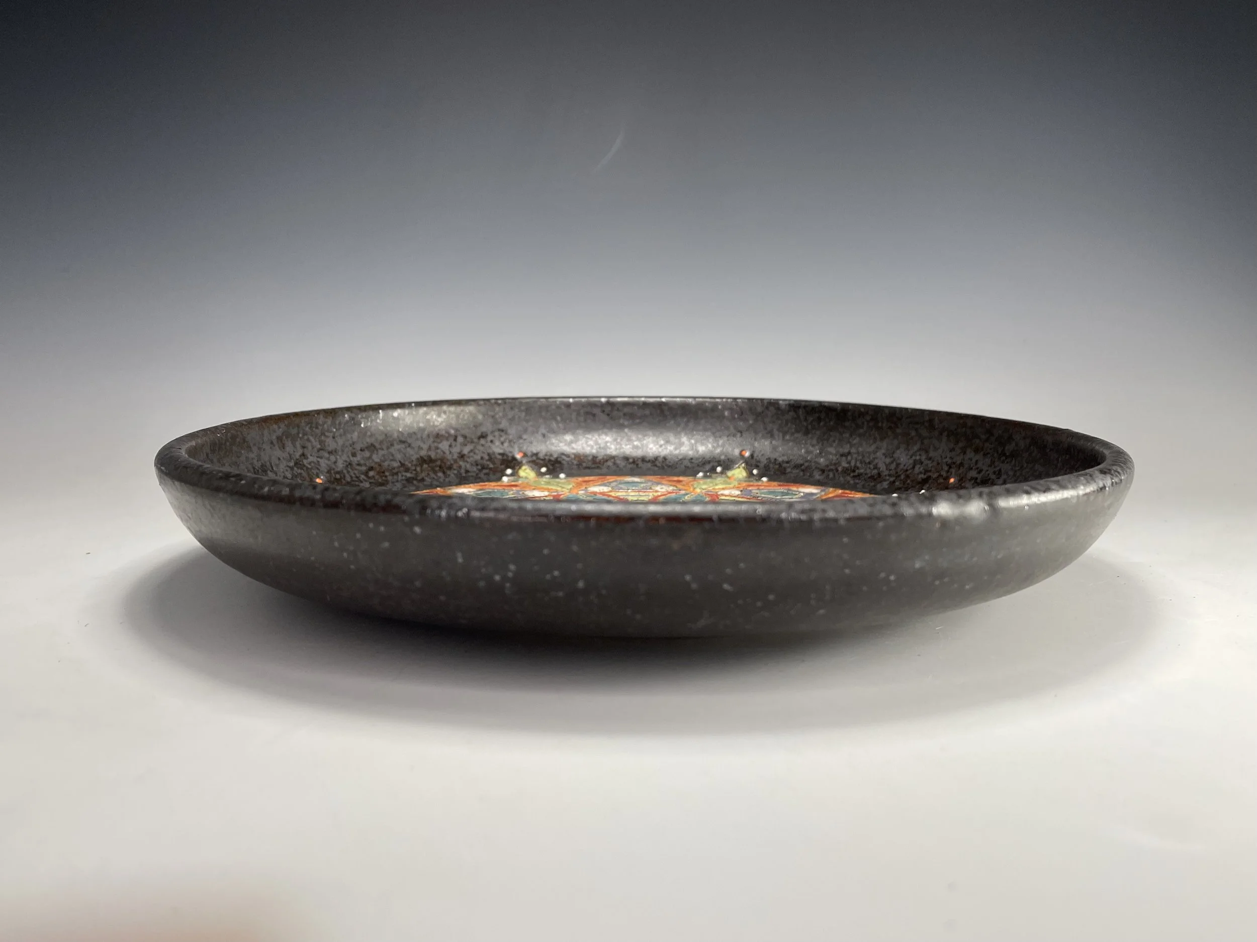 Side view of Colorful carved small stoneware plate