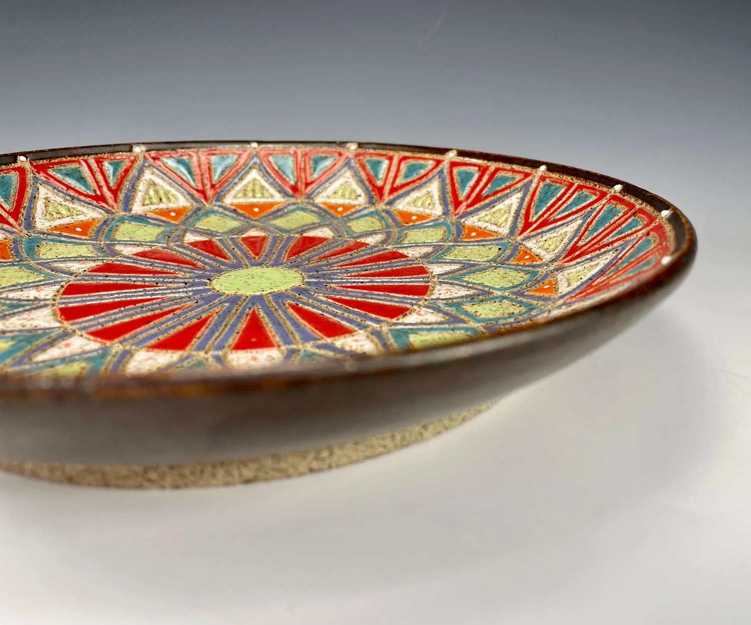 Side view of Kaleidoscope design stoneware plate dish
