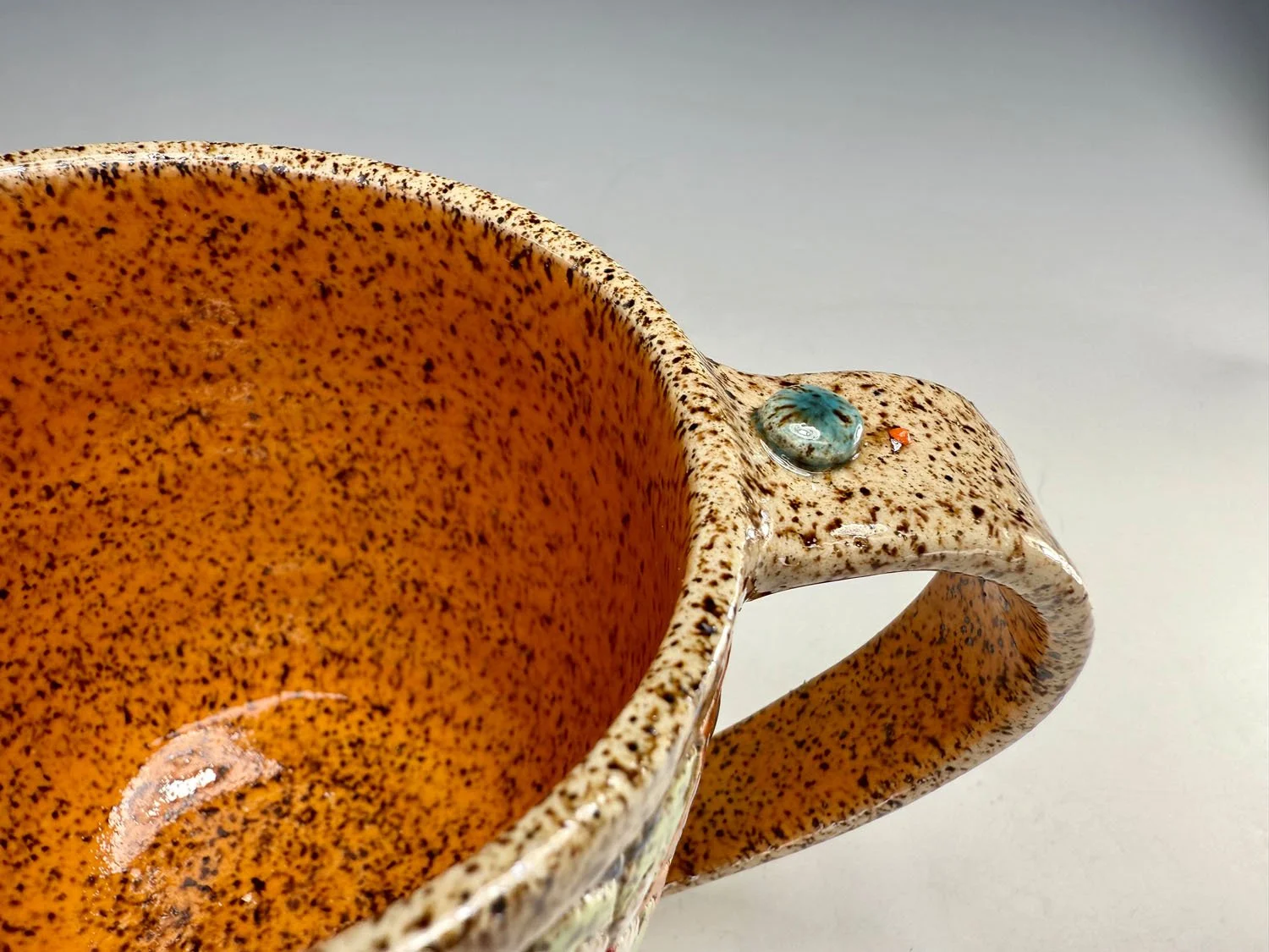 Interior of Colorful carved stoneware mug