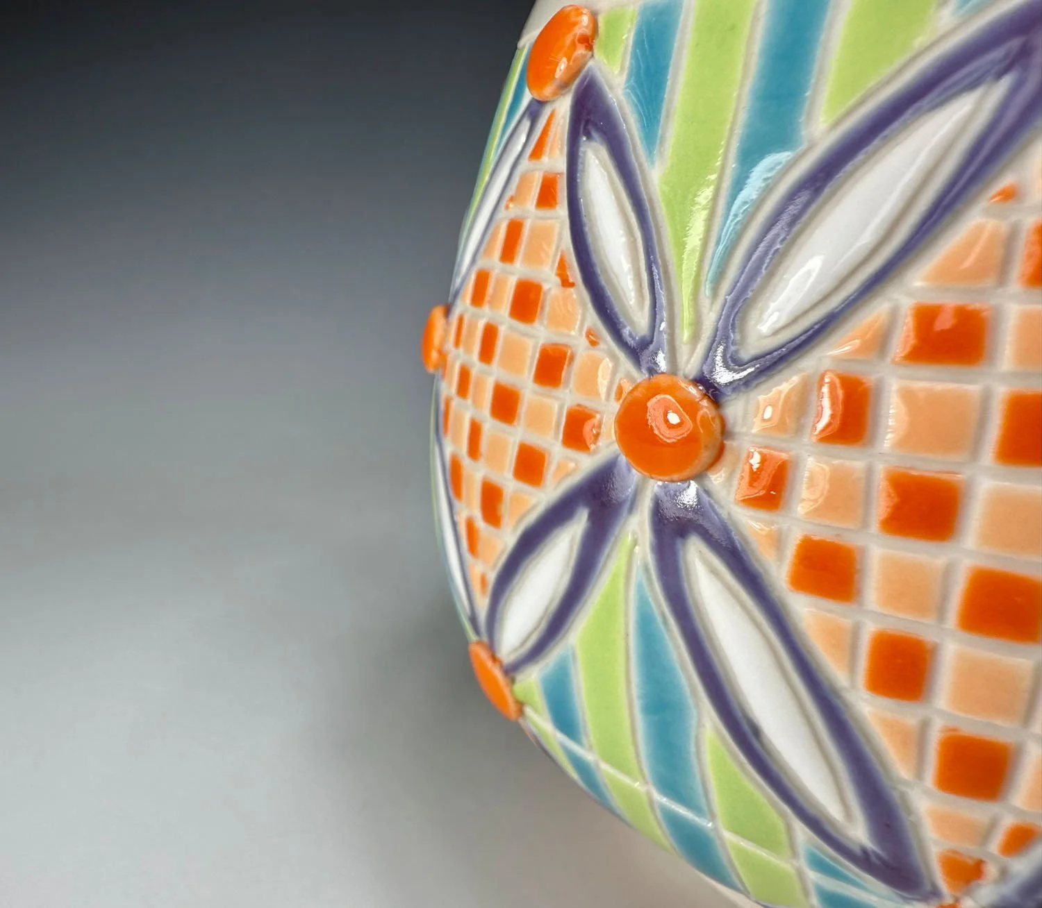 Closeup of design on Carved checkered porcelain mug