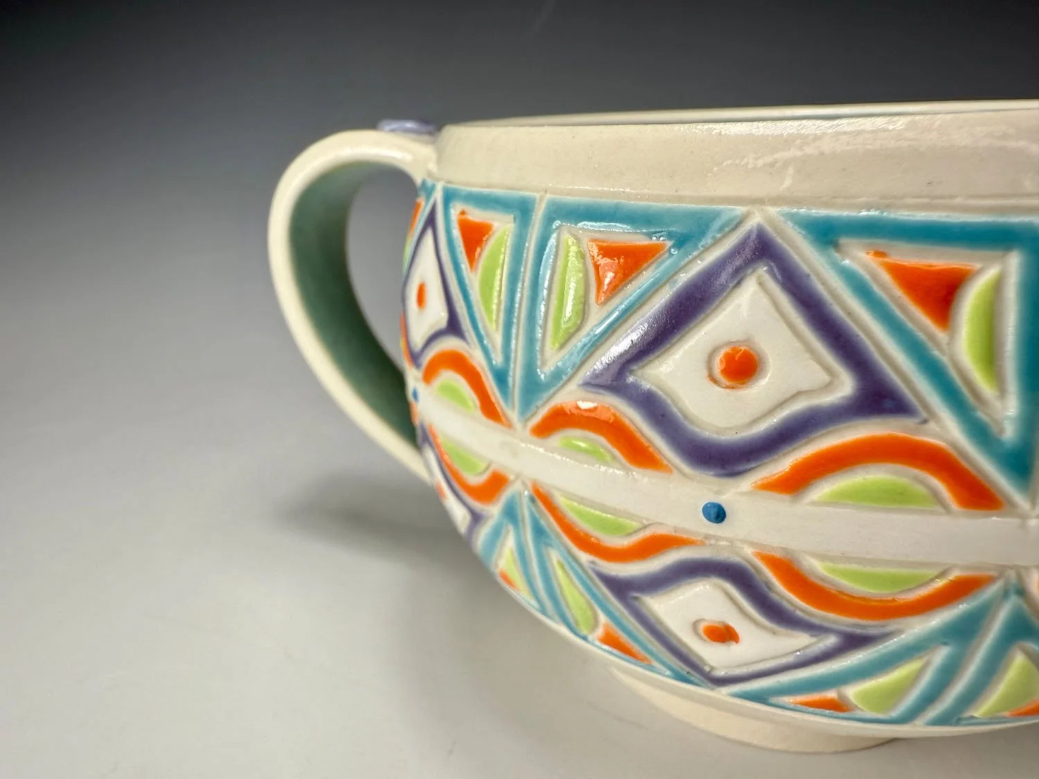 Closeup design of Aqua blue lime and orange porcelain mug