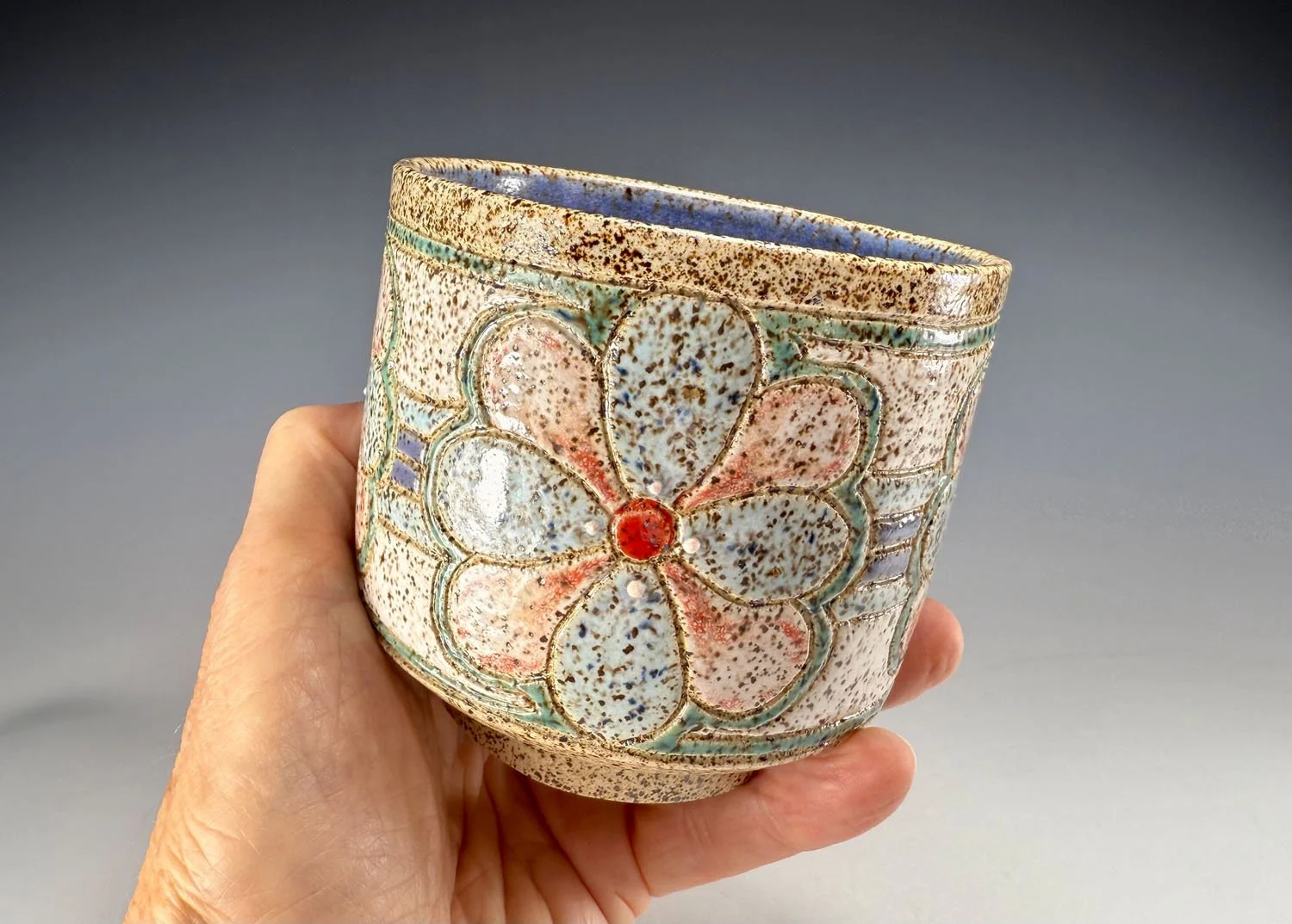 Hand holding Flower stoneware cup