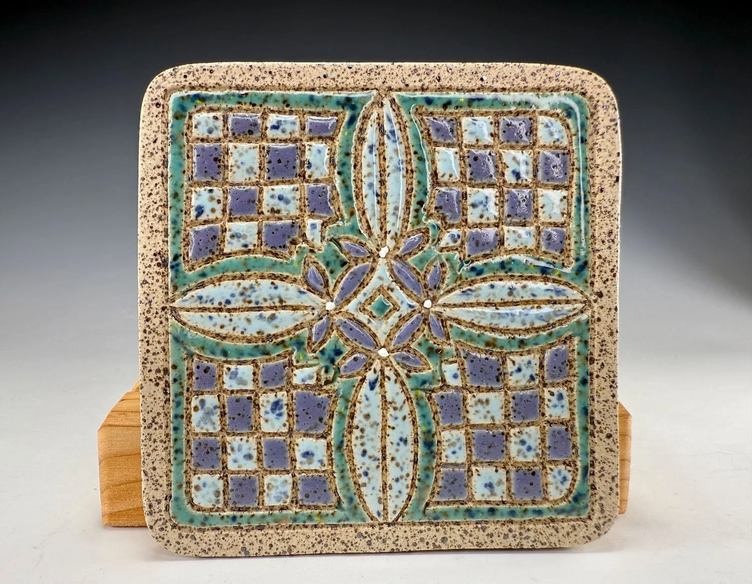 Full front of Hand carved stoneware coasters