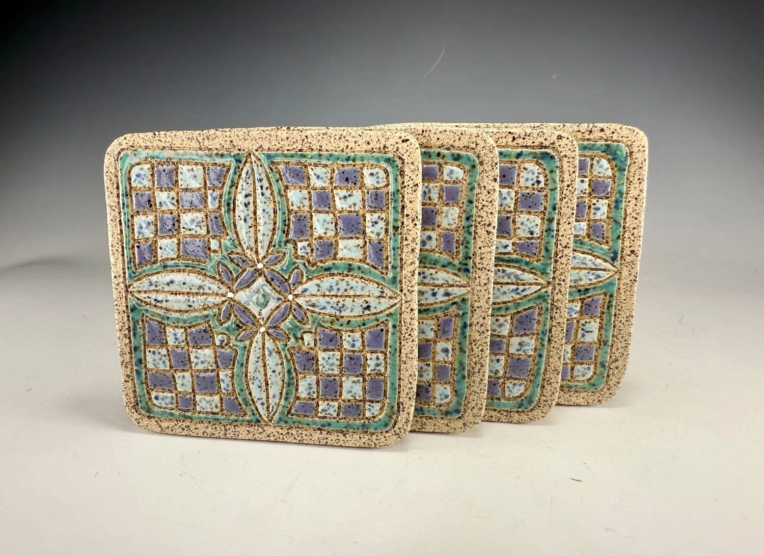 Four stoneware coasters Hand carved stoneware coasters