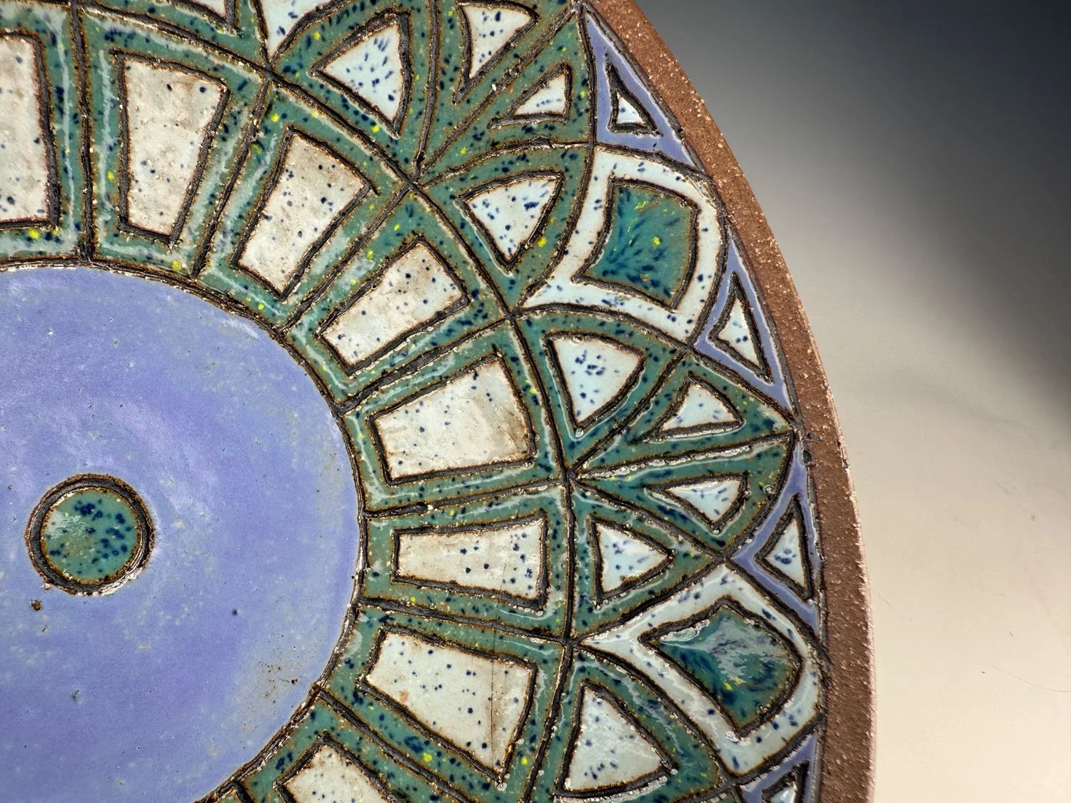 Closeup view 2 of Blue green carved red stoneware serving bowl