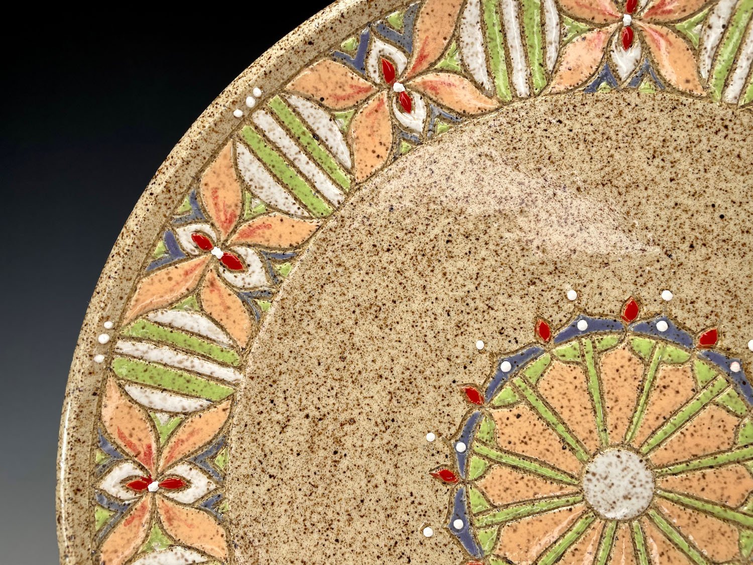 Closeup of design on Carved stoneware serving plate