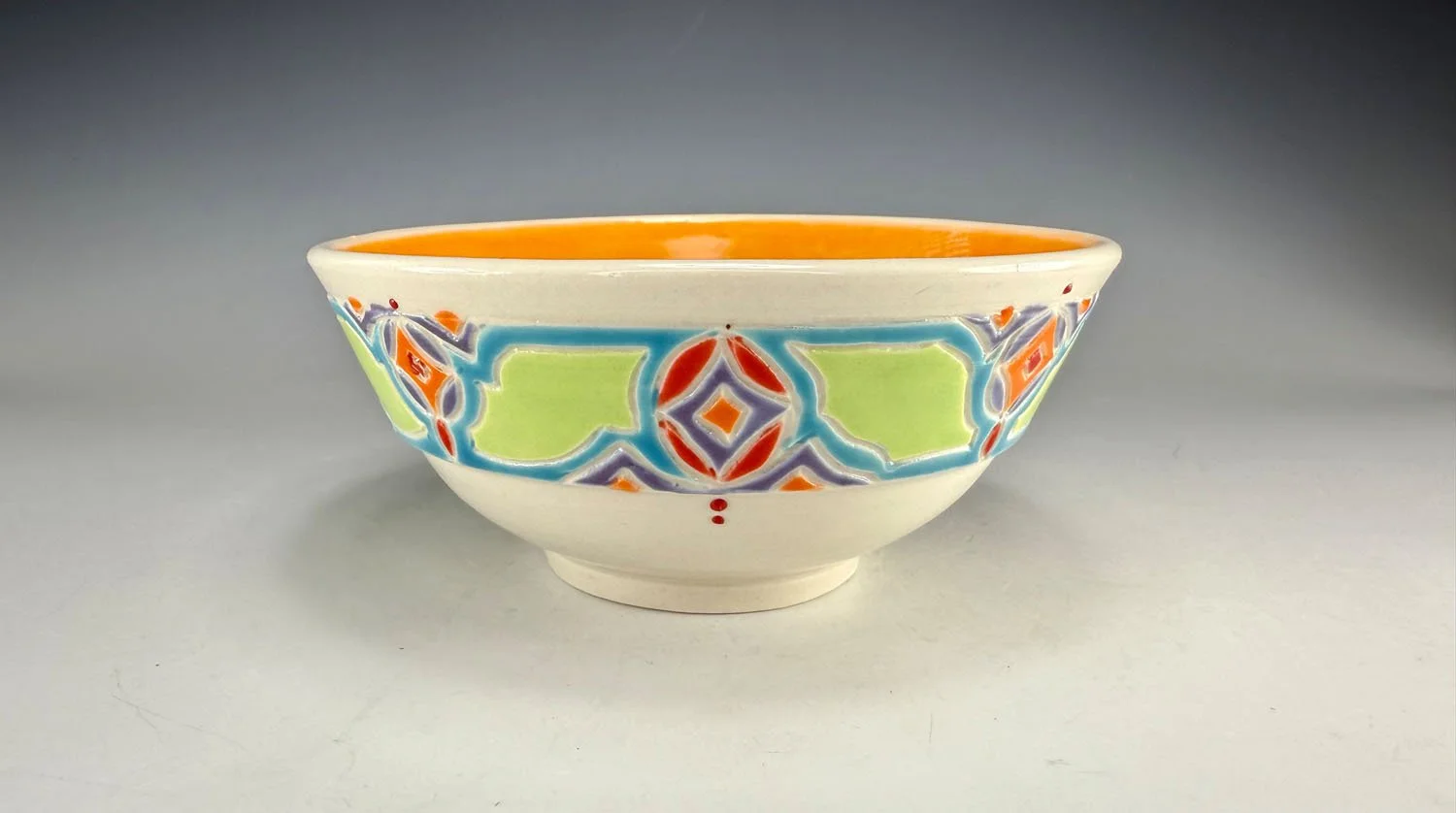 Bowl 1 of Tangerine lined porcelain two bowl snack set with carved outer bands