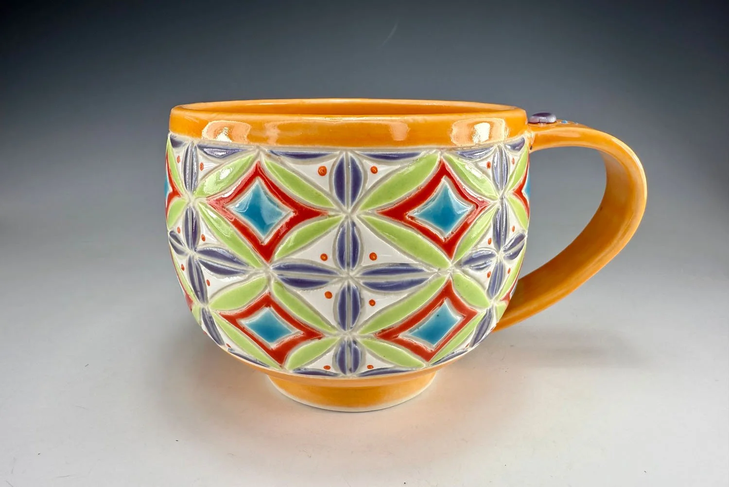 Orange carved porcelain mug