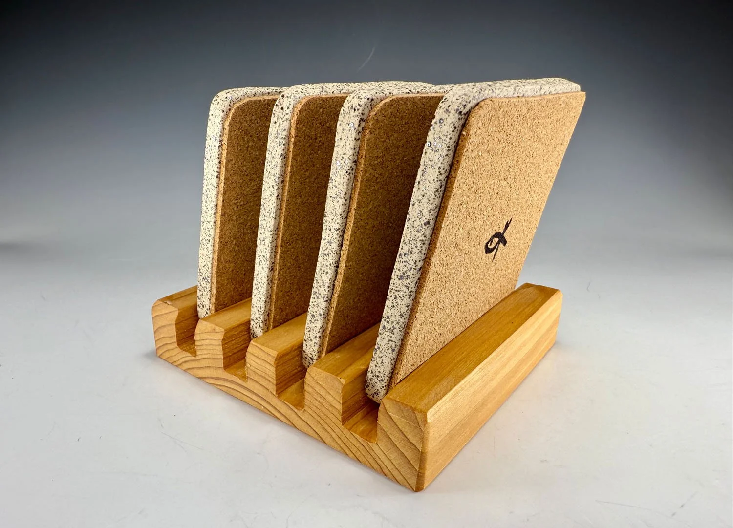 Cork backing on Hand carved stoneware coasters w stand