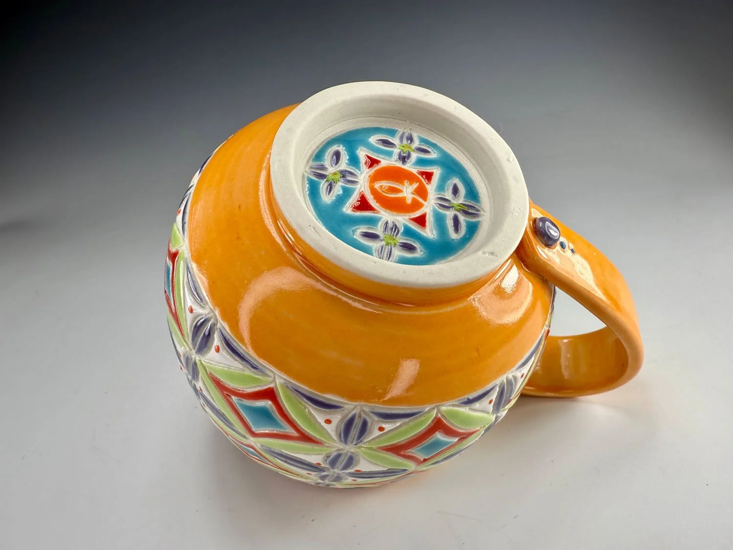 Bottom of Orange carved porcelain mug