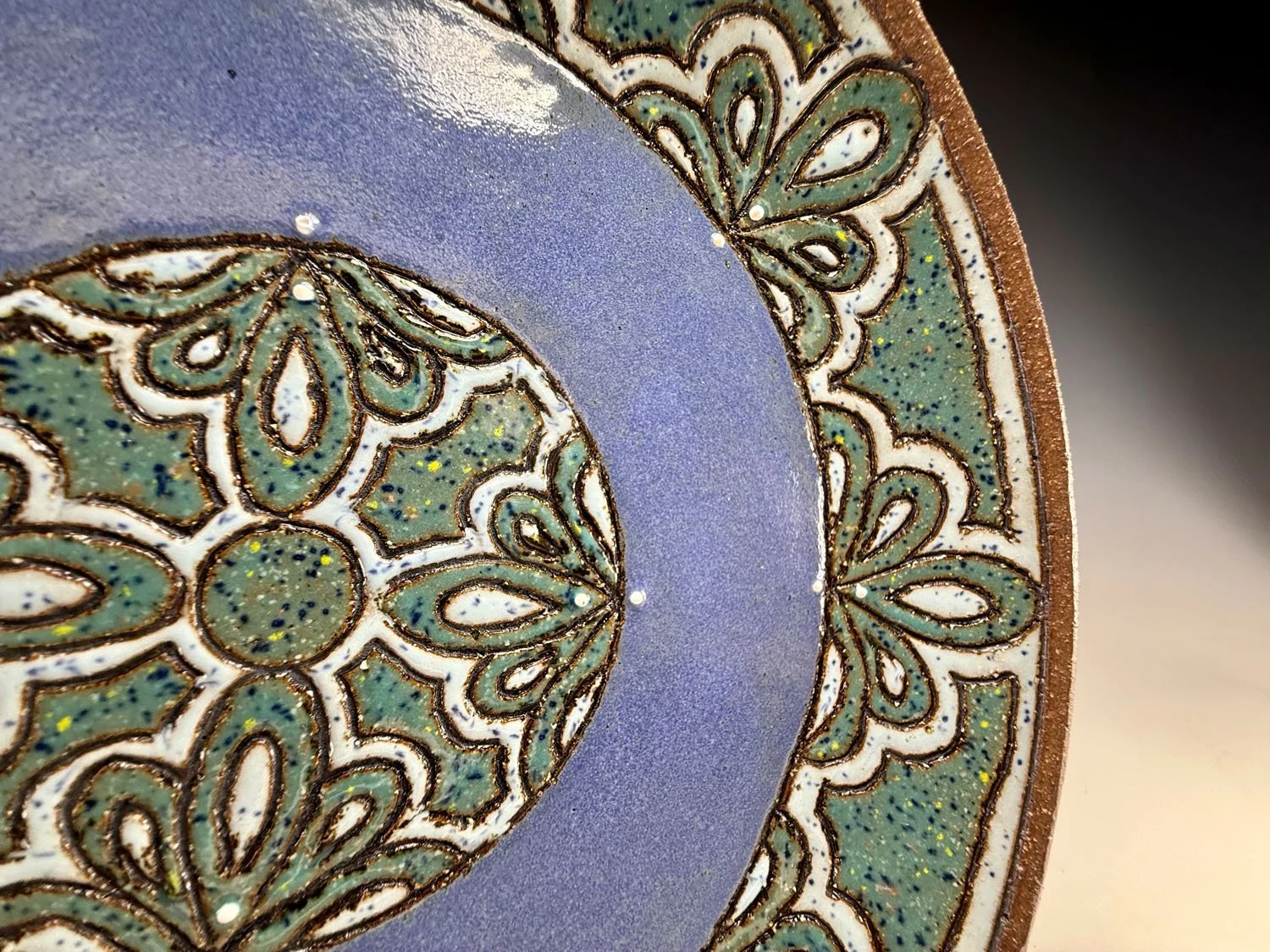 Closeup view of Carved stoneware plate bowl