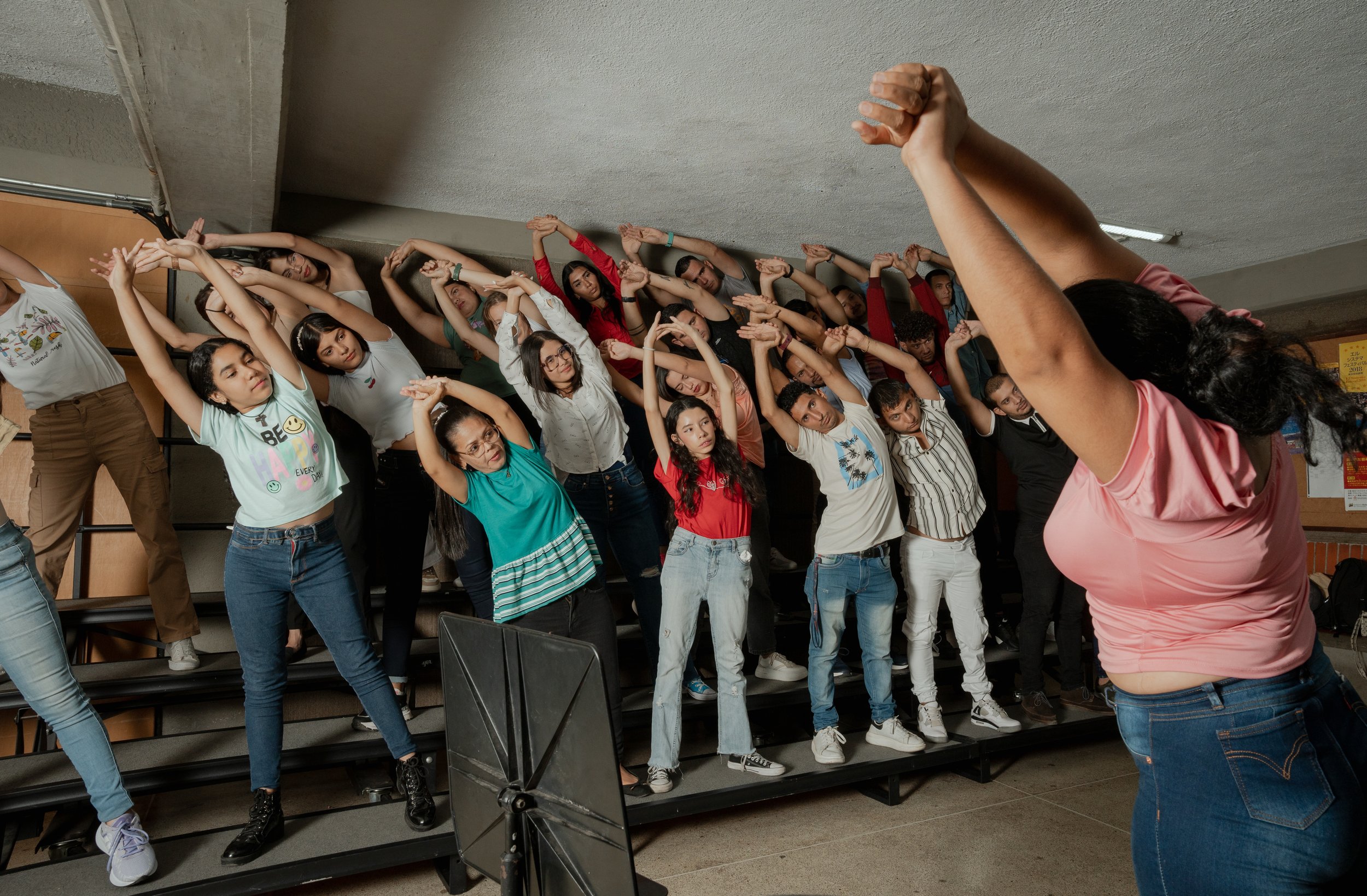 An important stretch. Members of the Deaf section of the White Hands Choir (El Coro de Manos Blancas) rehearse in Barquisimeto, Venezuela. February 2024.