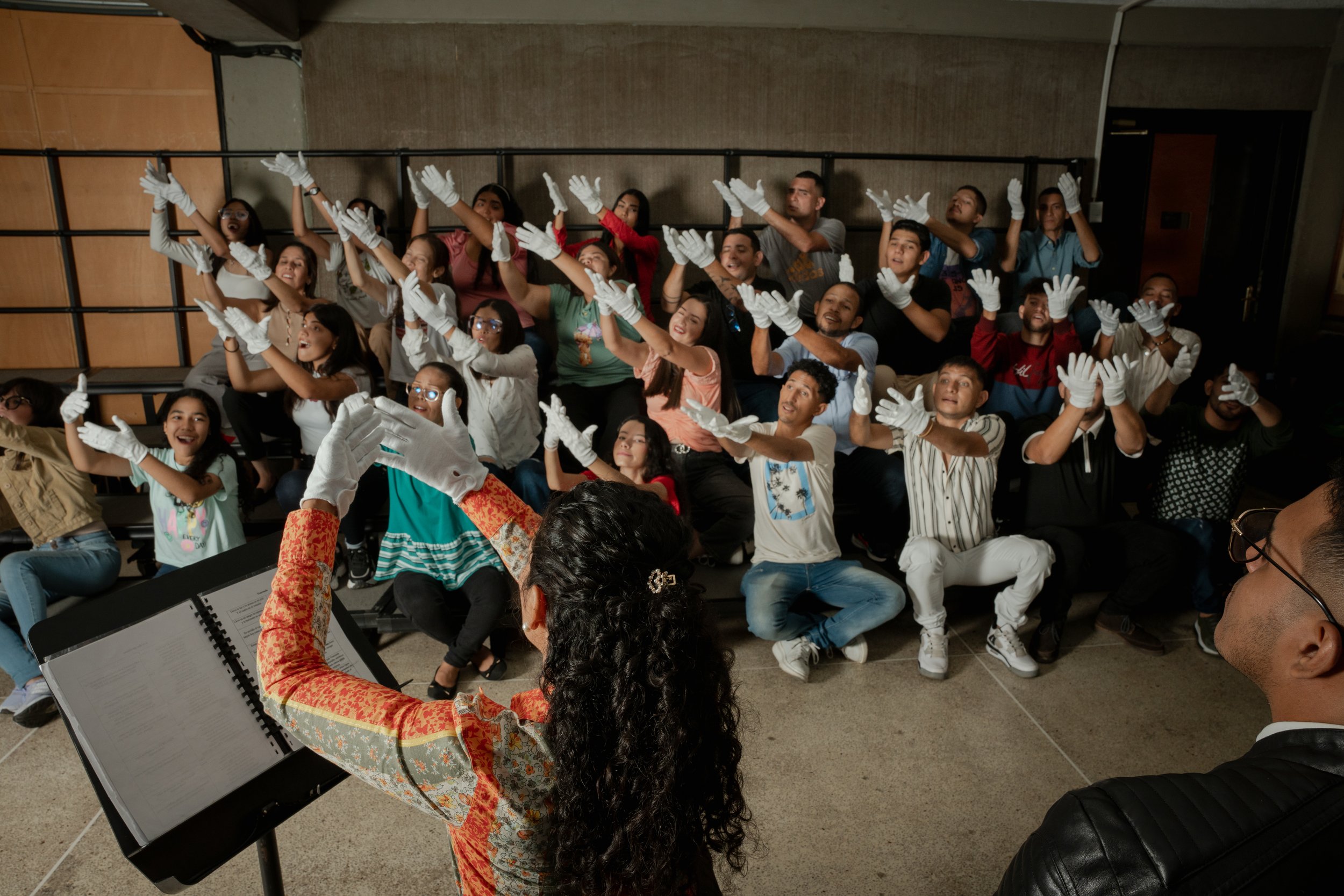 Assistant Director María Estefanía Prieto leads members of the Deaf section of the White Hands Choir (El Coro de Manos Blancas) rehearse in Barquisimeto, Venezuela. February 2024.
