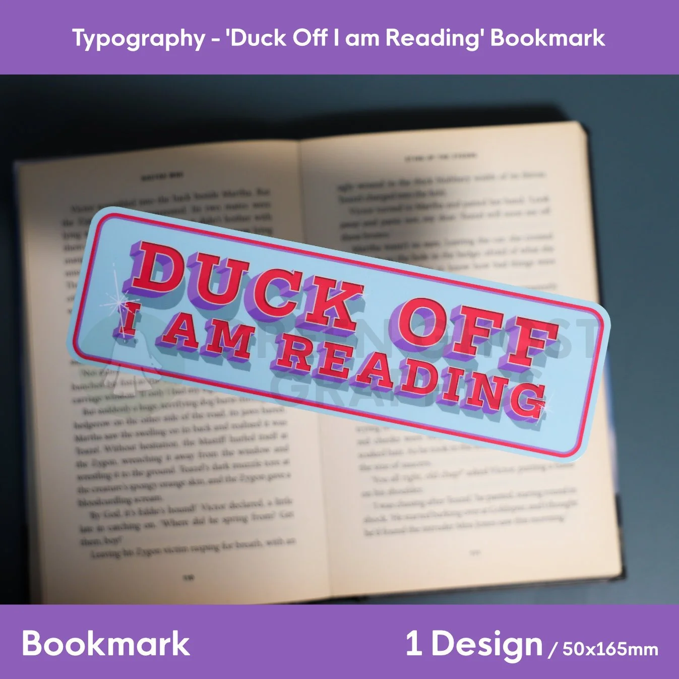 A glossy blue bookmark with rounded corners and red‑pink “DUCK OFF I AM READING” text resting on the pages of an open book.