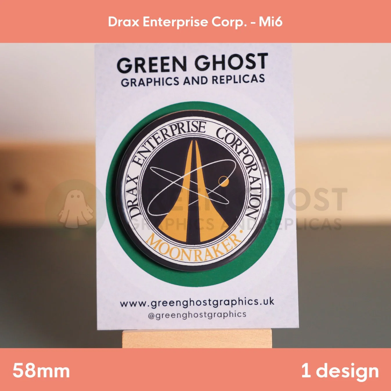 A round badge with black and gold “DRAX ENTERPRISE CORPORATION MOONRAKER” lettering and an orbit graphic shown on a branded backing card.