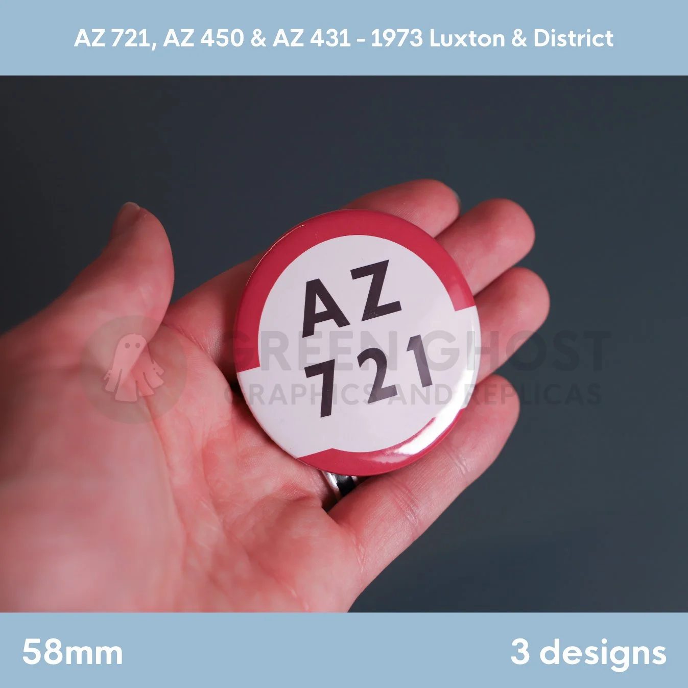 A round white badge with a red border and the text “AZ 721” held in a hand against a dark background.