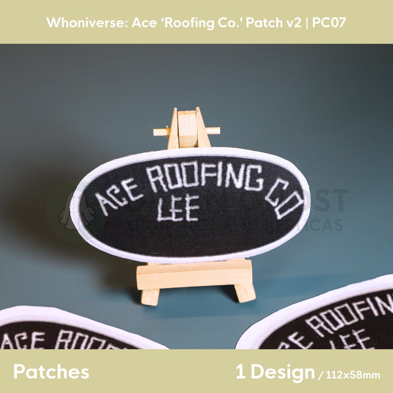Close up of the finished Roofing Co. oval patch on a small easel on a aqua green background.