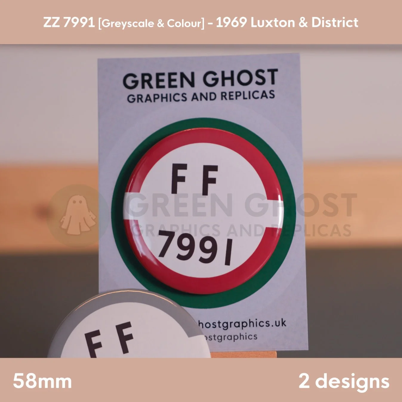 A round white badge with a red and grey border and the text “FF 7991” mounted on a branded backing card on a wooden easel.