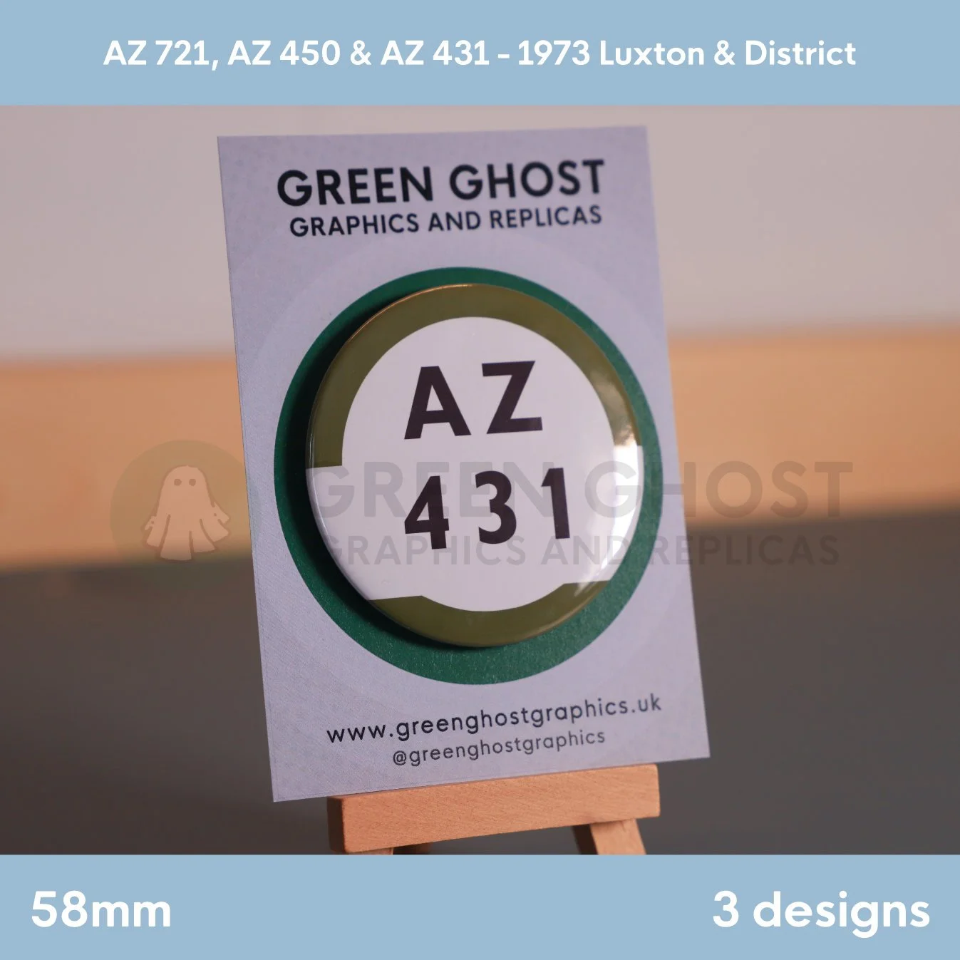 A round white badge with a green border and the text “AZ 431” displayed on a branded backing card on a wooden easel.