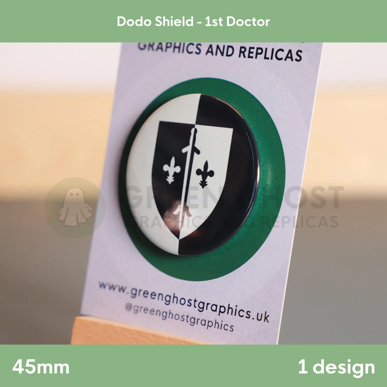 A round badge with a split black and white shield and central line design attached to a branded display card.