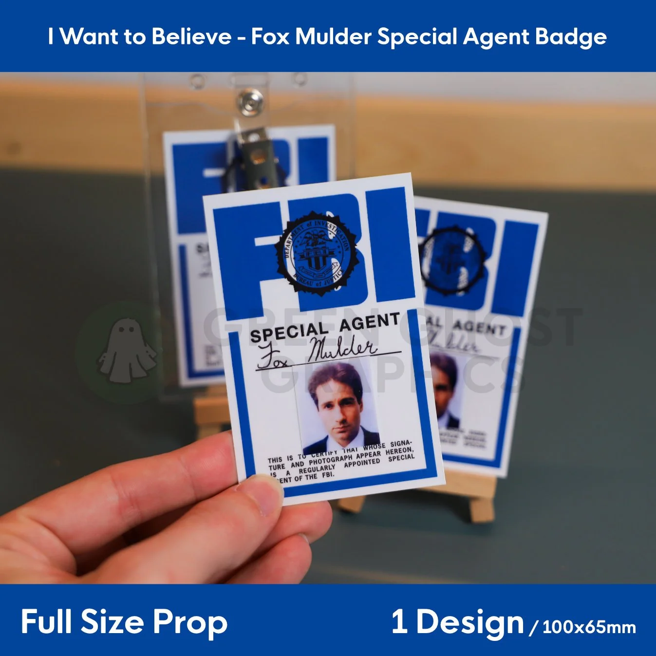 A rectangular blue and white FBI identification card reading “SPECIAL AGENT Fox Mulder” held in a hand in front of matching display badges.