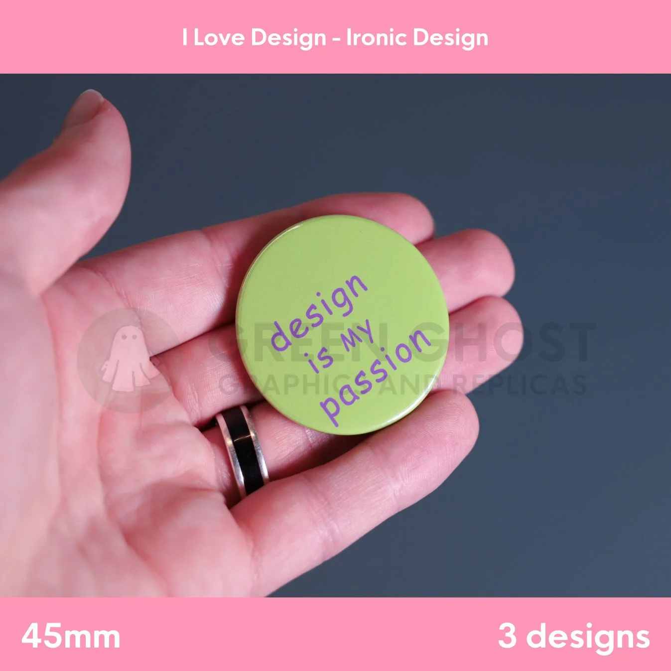 A round green badge with purple text reading “design is my passion” held in a hand against a grey background.