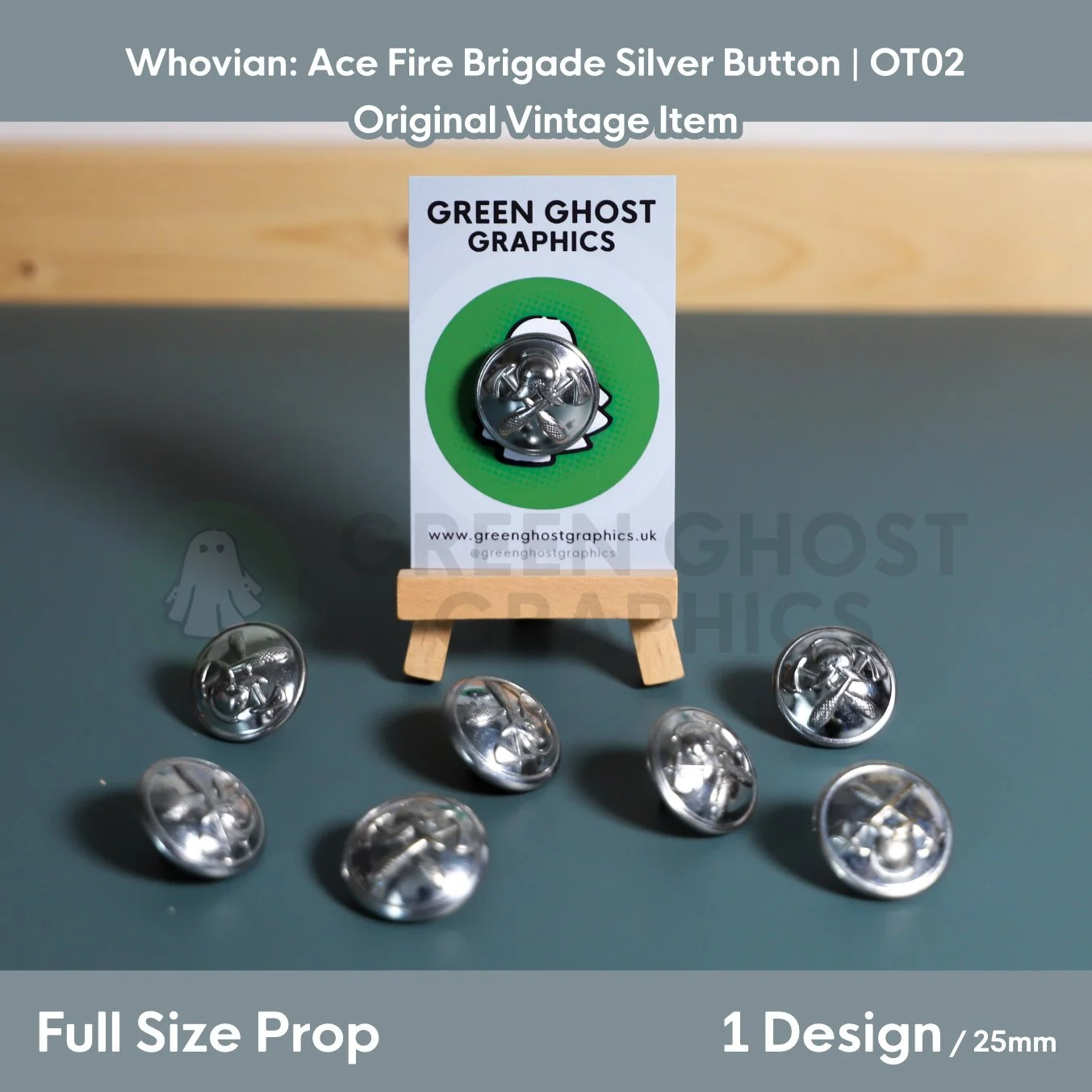 A circular silver button featuring a fire helmet and crossed axes mounted on a Green Ghost Graphics display card with matching buttons arranged around it.