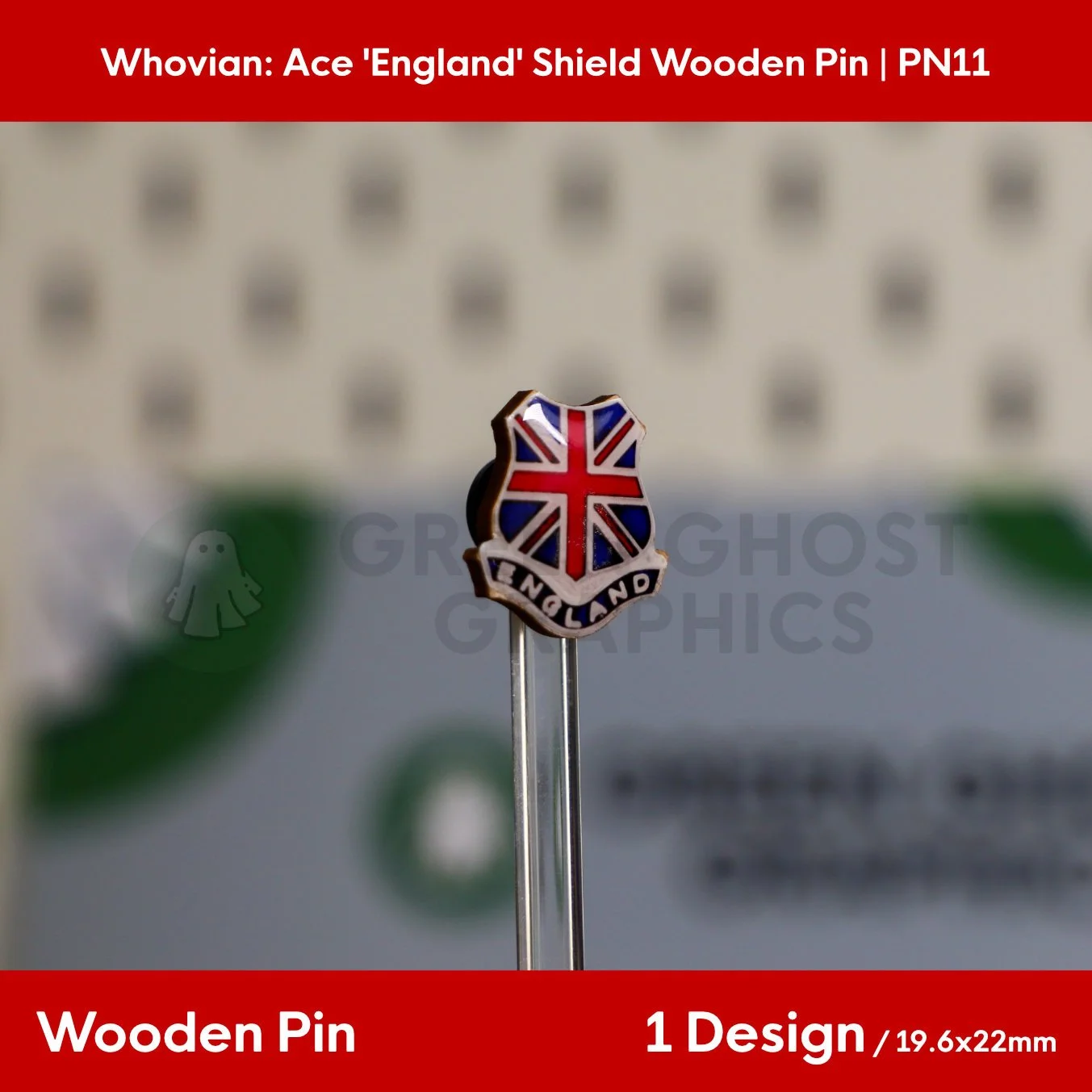 A shield‑shaped wooden pin featuring a red, white, and blue Union Jack design with the text “ENGLAND” displayed upright on a clear stand.