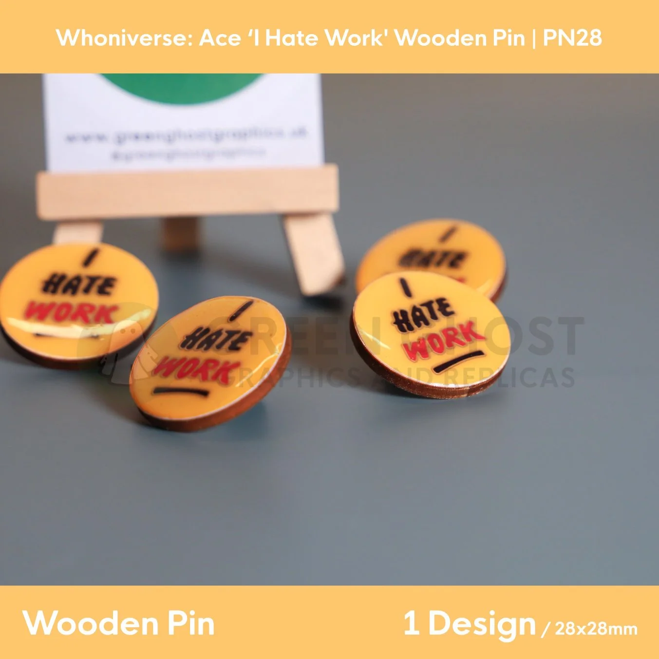 A circular wooden pin featuring coloured text “I HATE WORK” with a number of other pins in the background.
