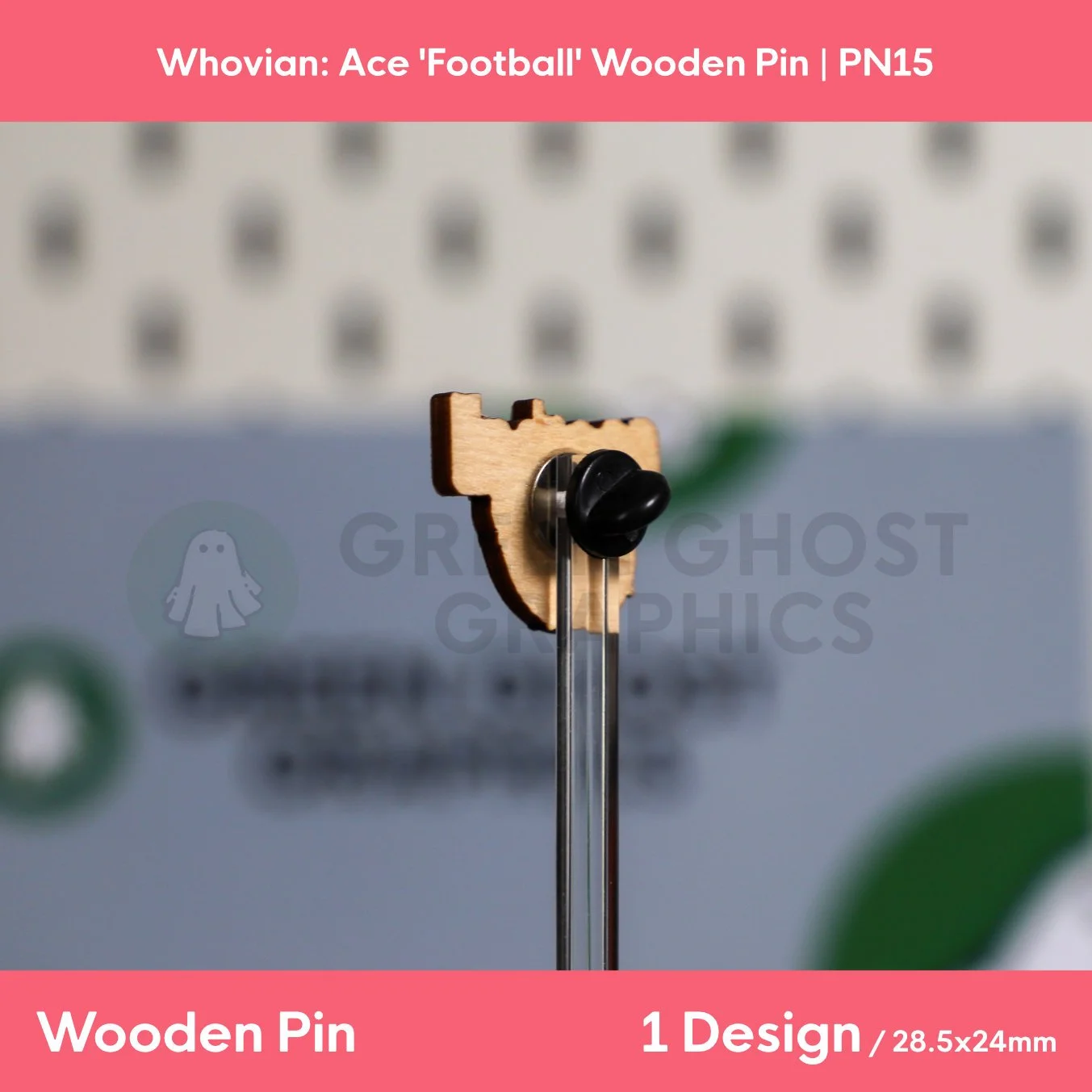 A colourful wooden pin showing the word “Football” above a red and blue football graphic presented on a clear stand against a blurred background.