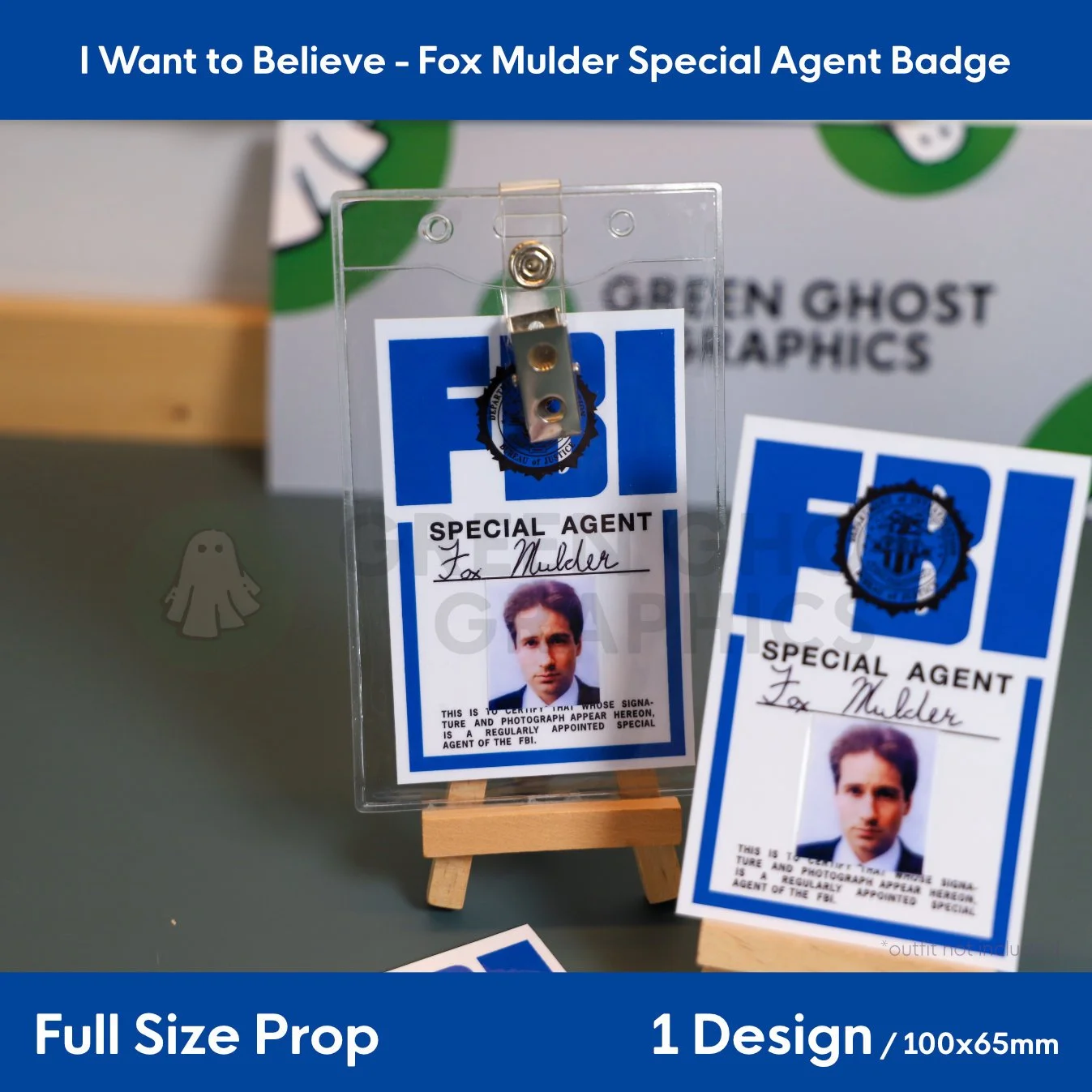 A blue and white identification card with “SPECIAL AGENT Fox Mulder” text and a photo portrait shown in a clear plastic badge holder beside a matching card on an easel.