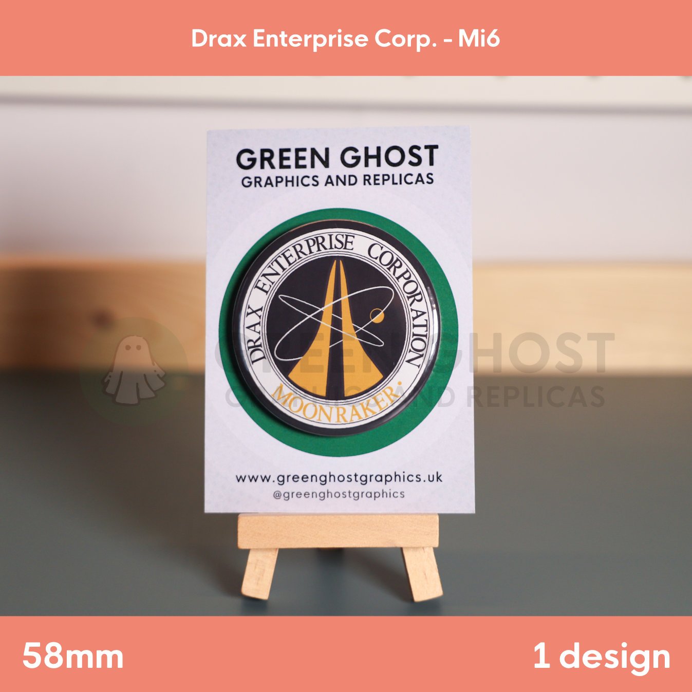 A circular badge featuring gold “DRAX ENTERPRISE CORPORATION MOONRAKER” text and a rocket‑and‑orbit symbol mounted on a branded card on a wooden easel.
