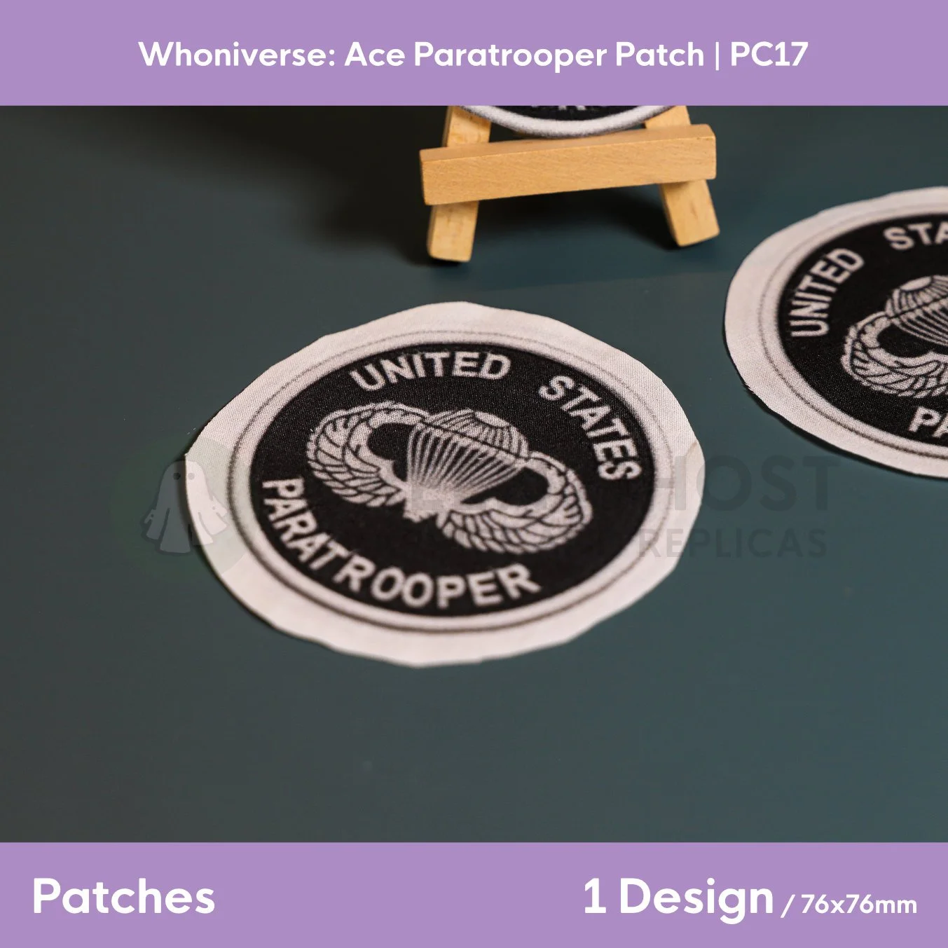 Close up of the uncut unfinished version of the Paratrooper patch design, on a plain aqua green background.