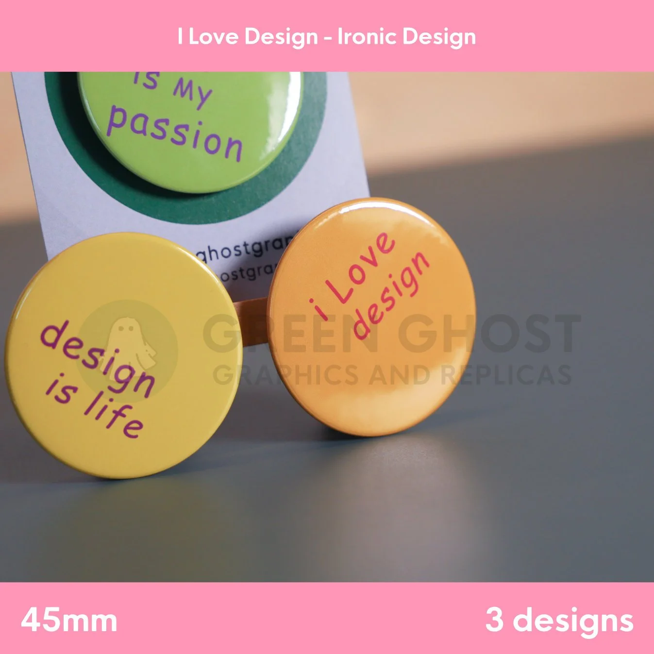 A trio of colourful round badges with ironic design slogans attached to a branded card against a grey backdrop.