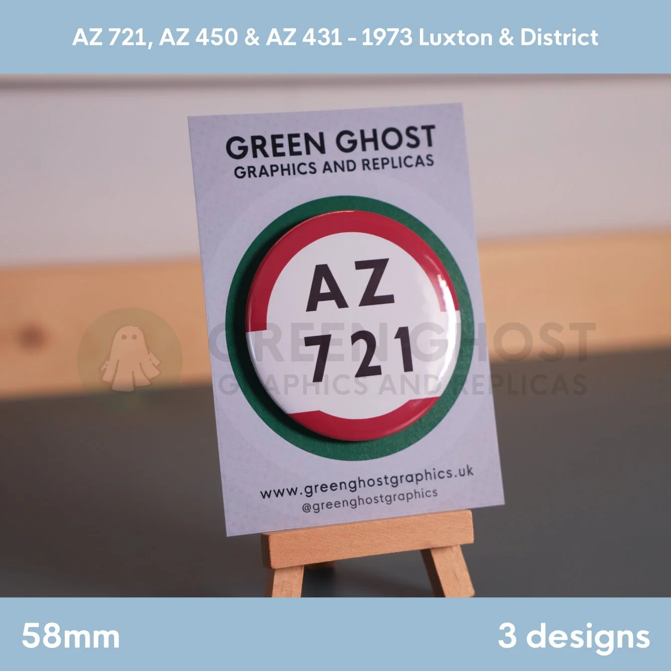 A round white badge with a red and green border and the text “AZ 721” mounted on a branded backing card on a wooden easel.