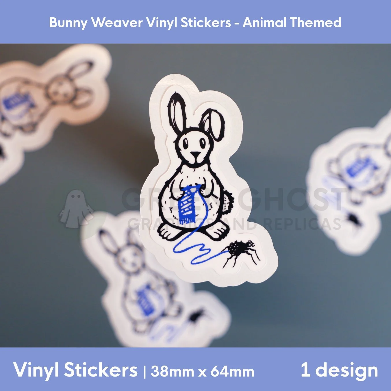Vinyl sticker with a drawing of a black outlined rabbit with a small spider to its right, weaving a blue scarf from the thread of the spider.